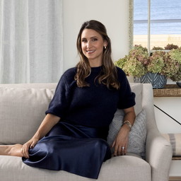 a woman sitting on a couch in a living room