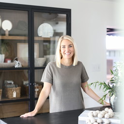 a woman standing in front of a black table