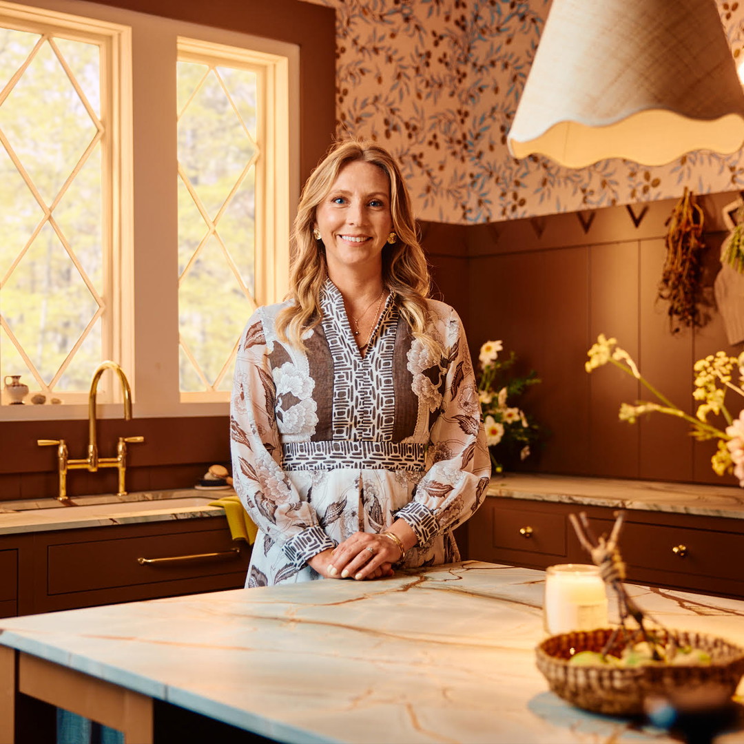 a woman standing in a kitchen next to a counter