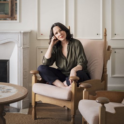 a woman sitting in a chair in a living room