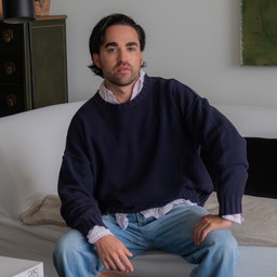 a man sitting on a couch in a living room