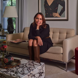 a woman sitting on a couch in a living room