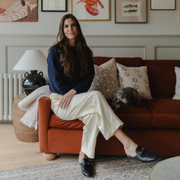 a woman sitting on a couch in a living room