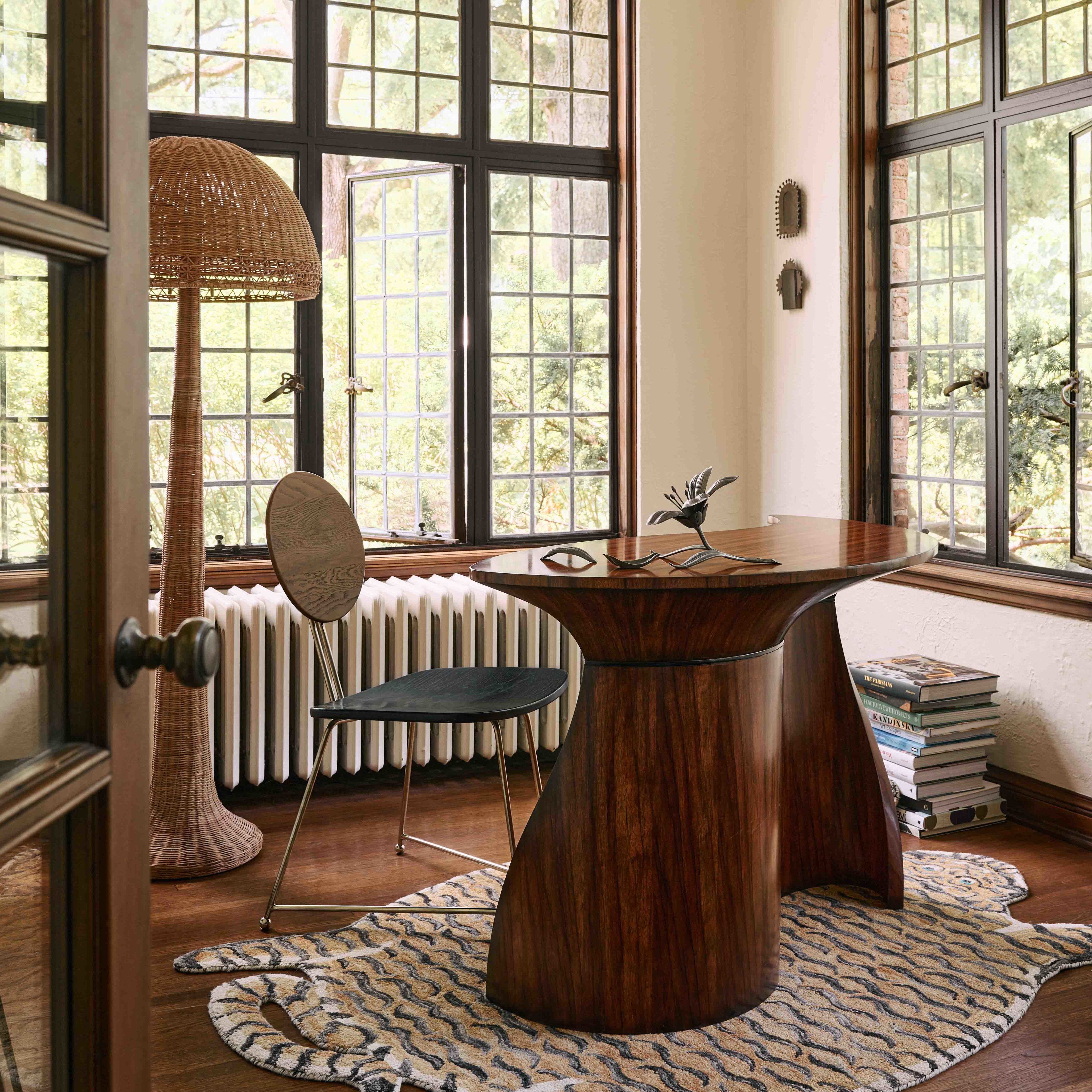 a room with a table, chair, radiator and a radiator