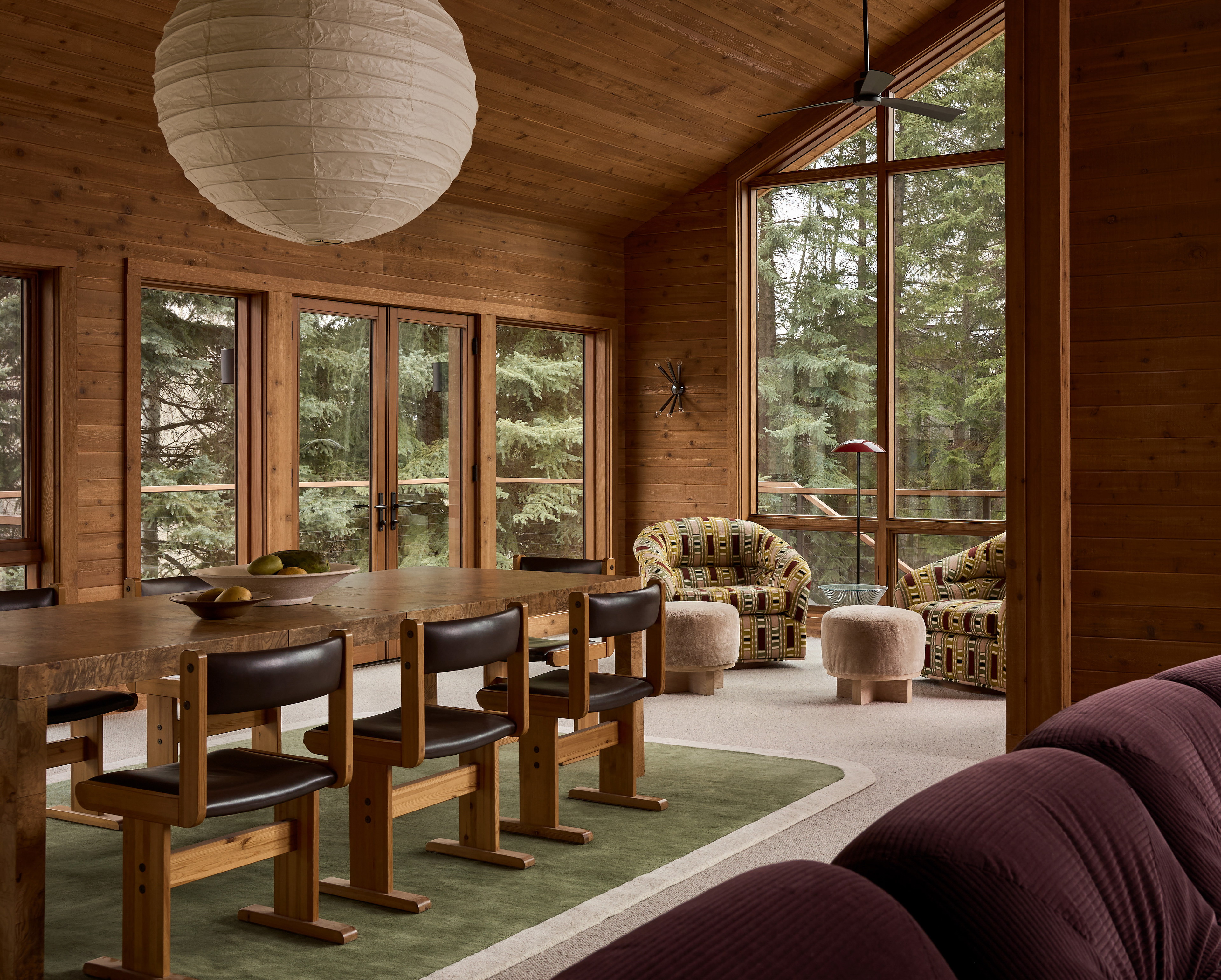 a living room filled with furniture and lots of windows