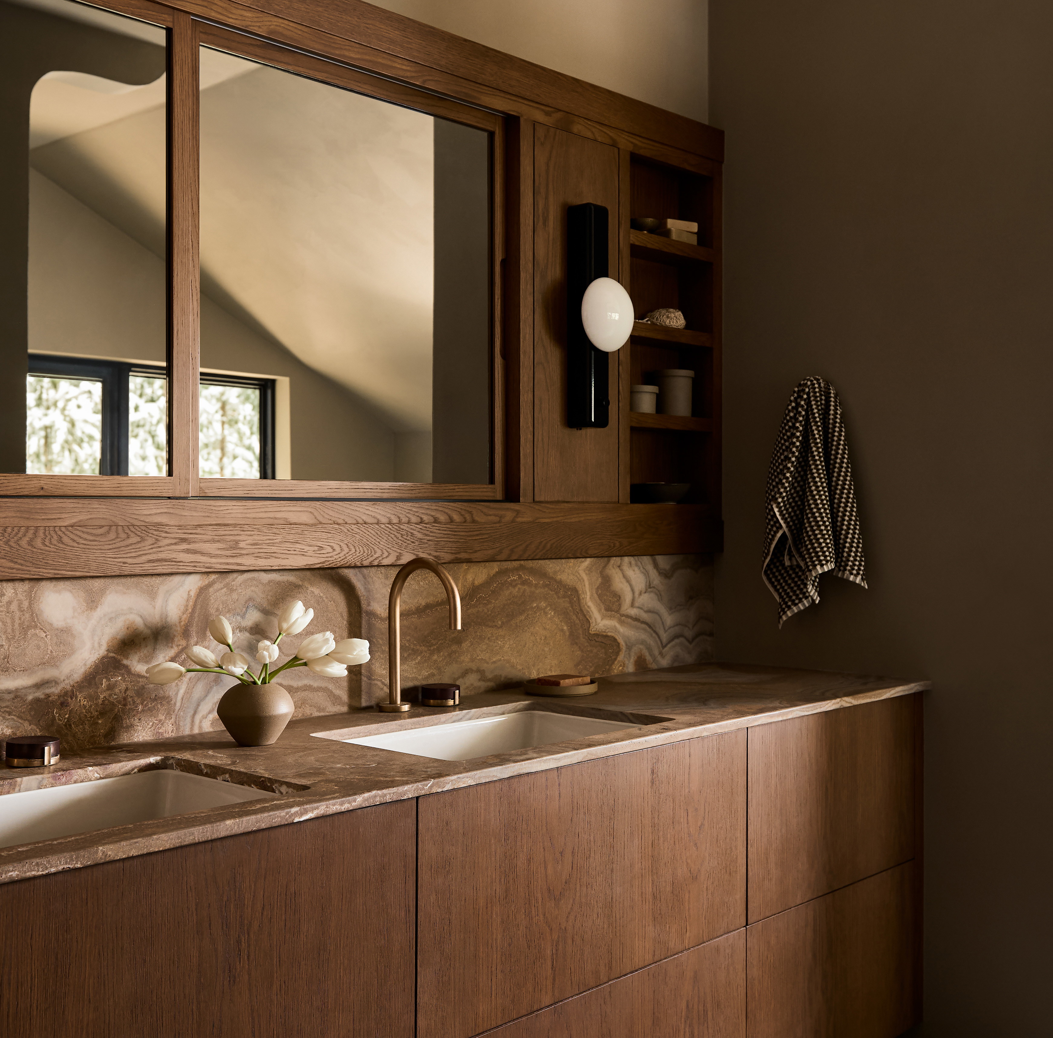 a bathroom with two sinks and a large mirror