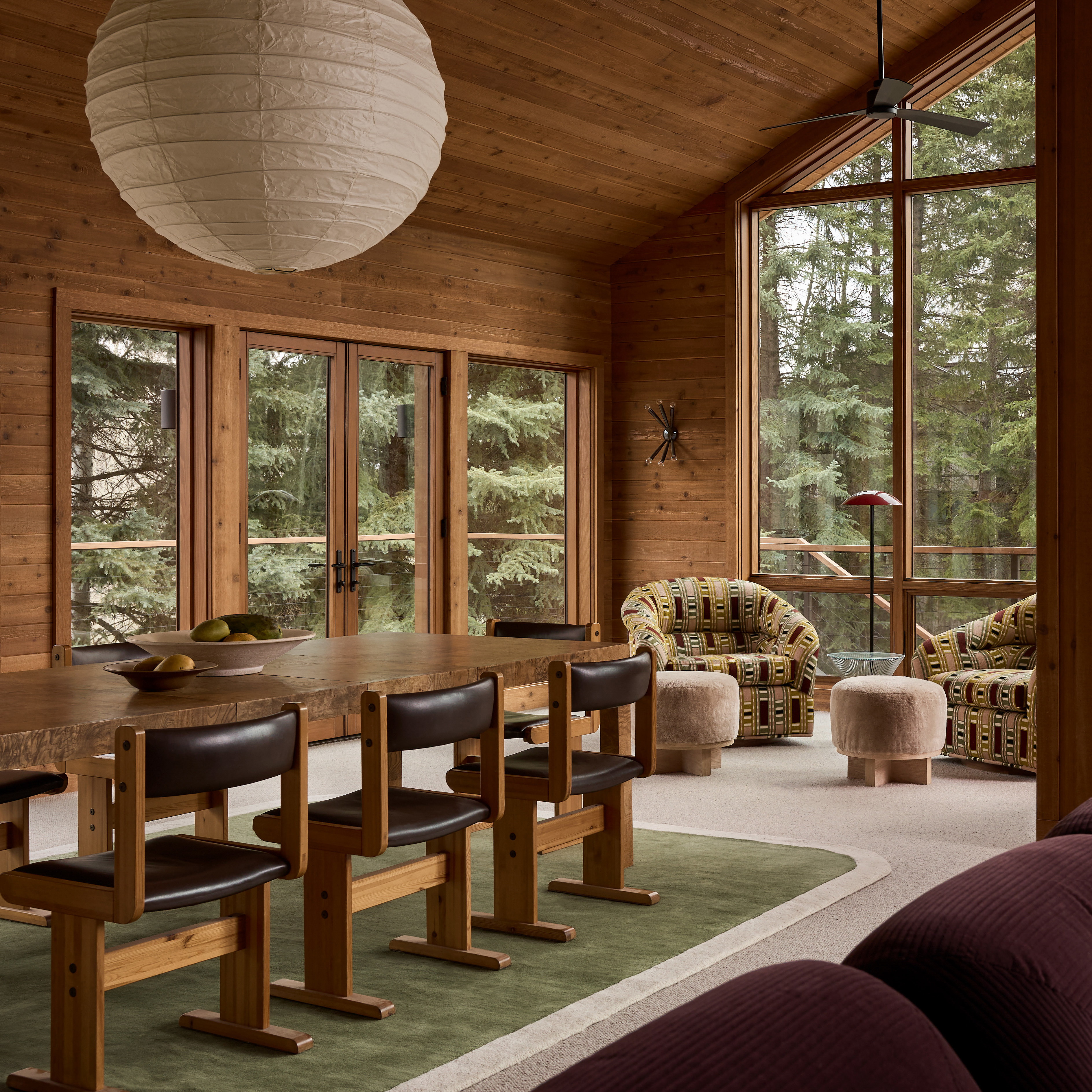 a living room filled with furniture and lots of windows