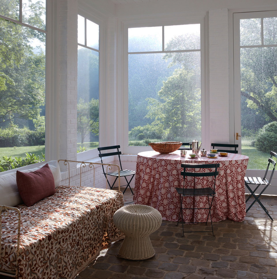 a room with a table and chairs and a bench