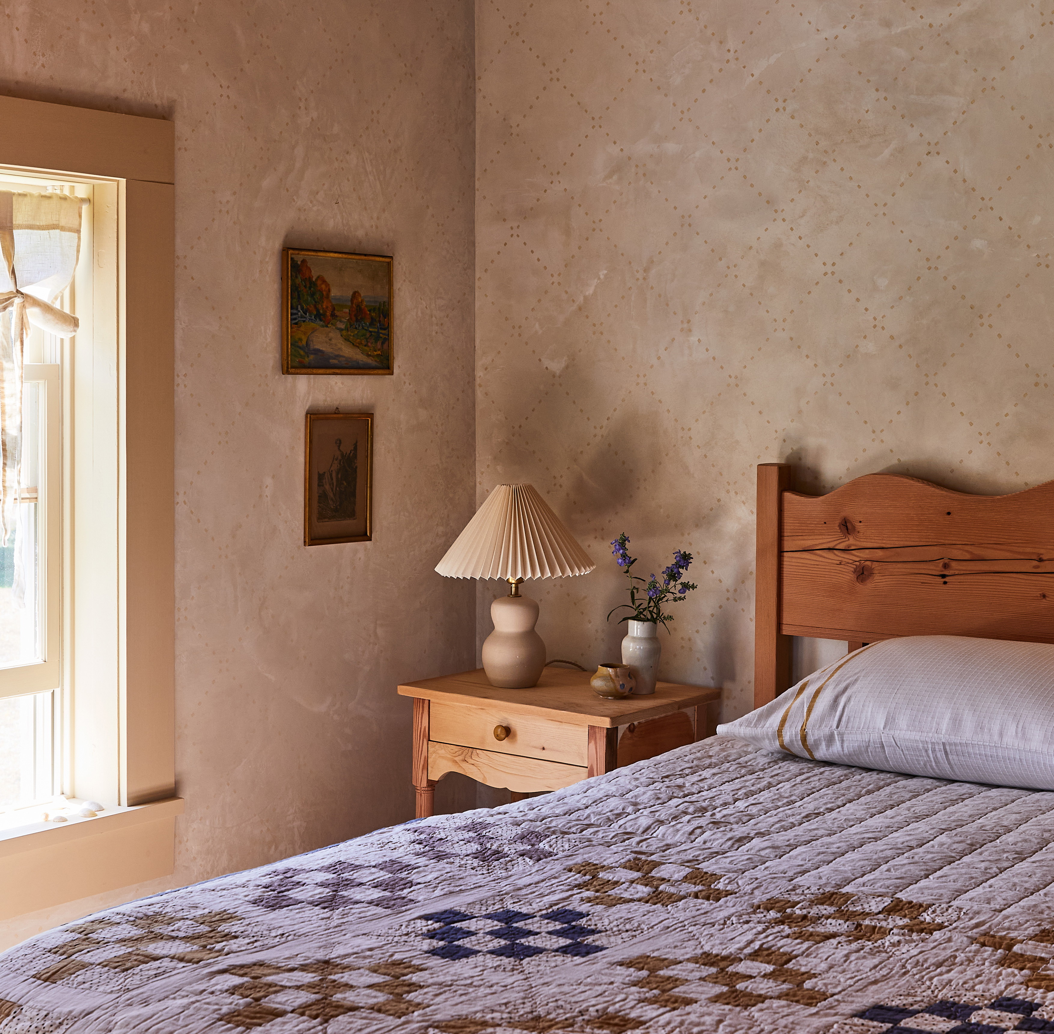 a bedroom with a large bed and a window