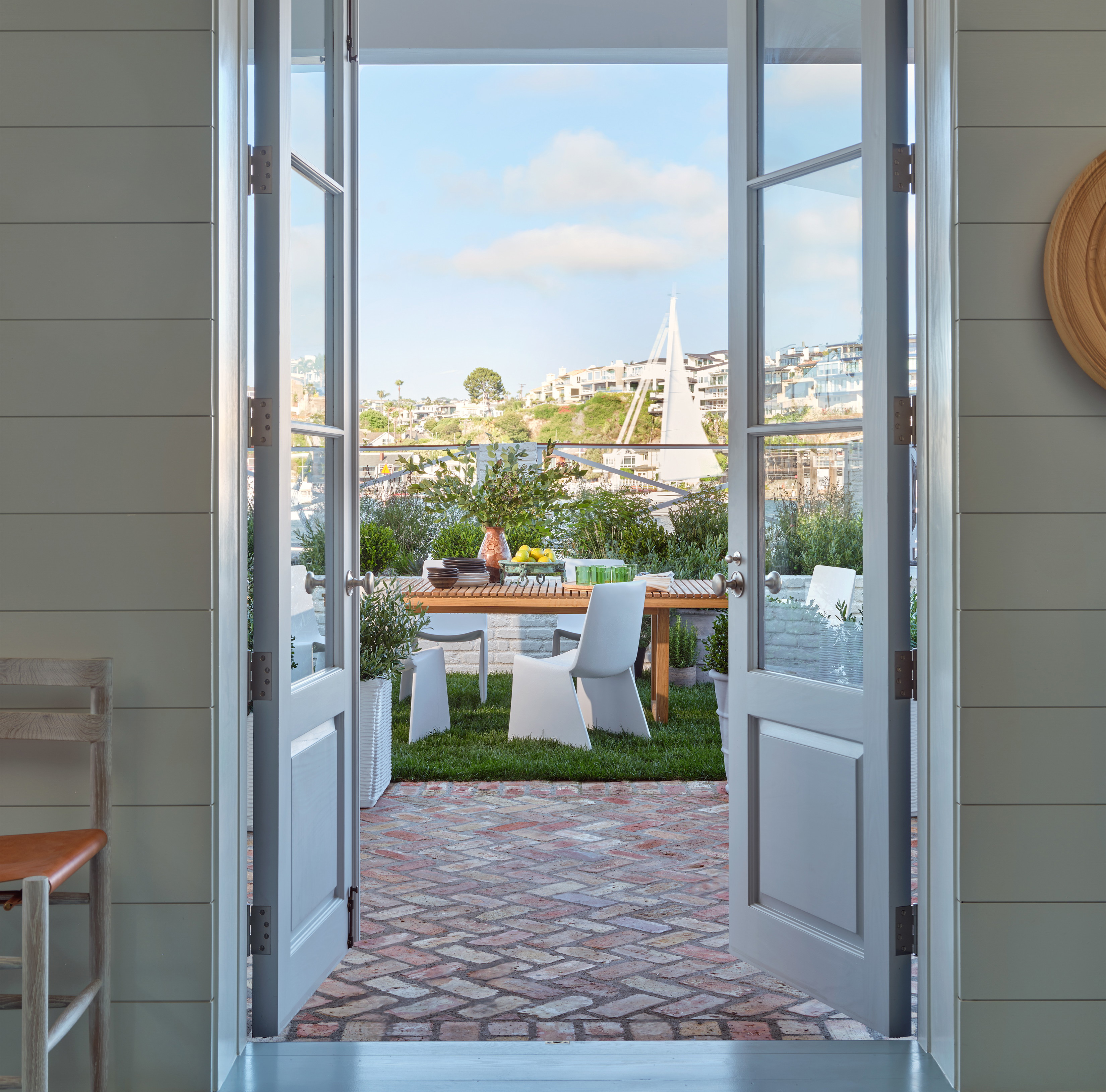 an open door leading to a patio with a table and chairs