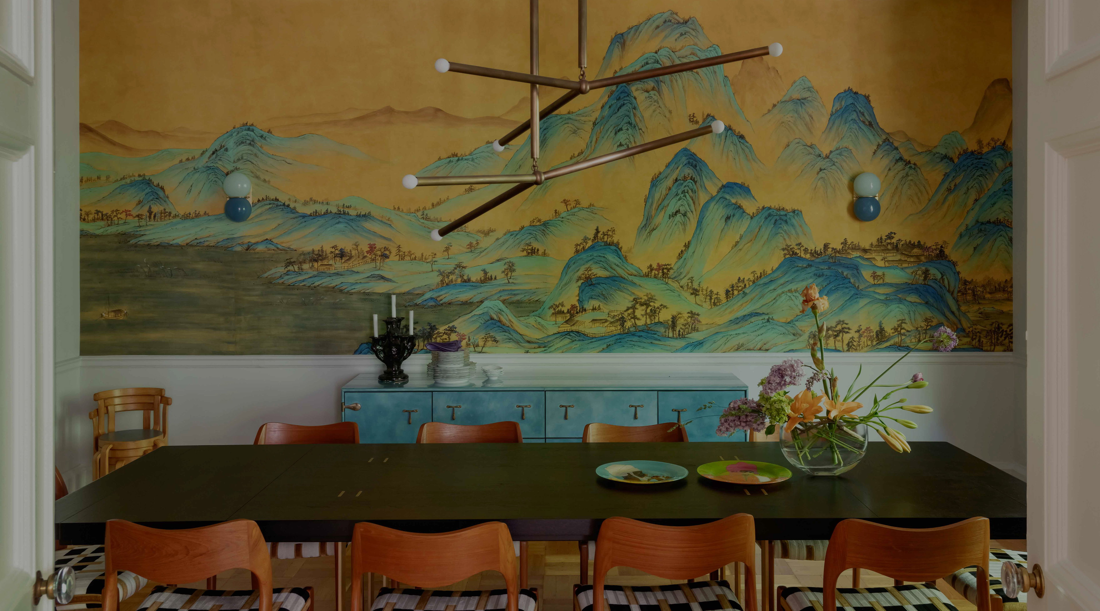 a dining room with a large painting on the wall