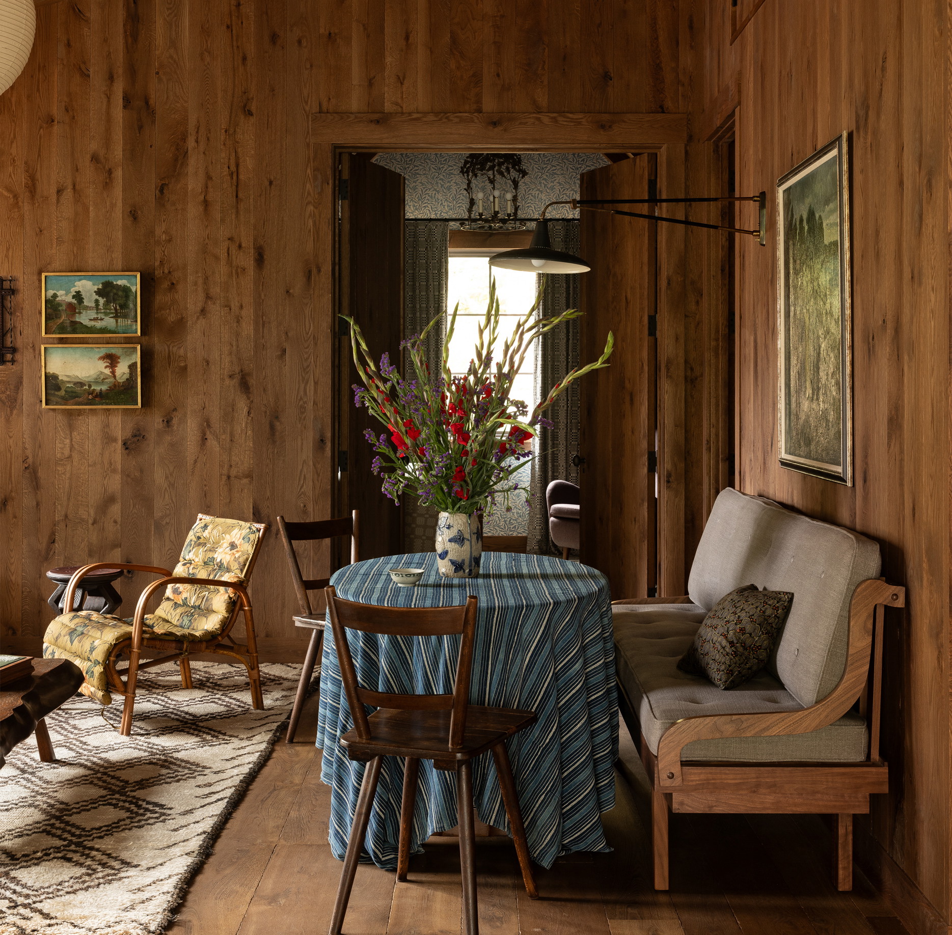 a living room with wood paneling and furniture