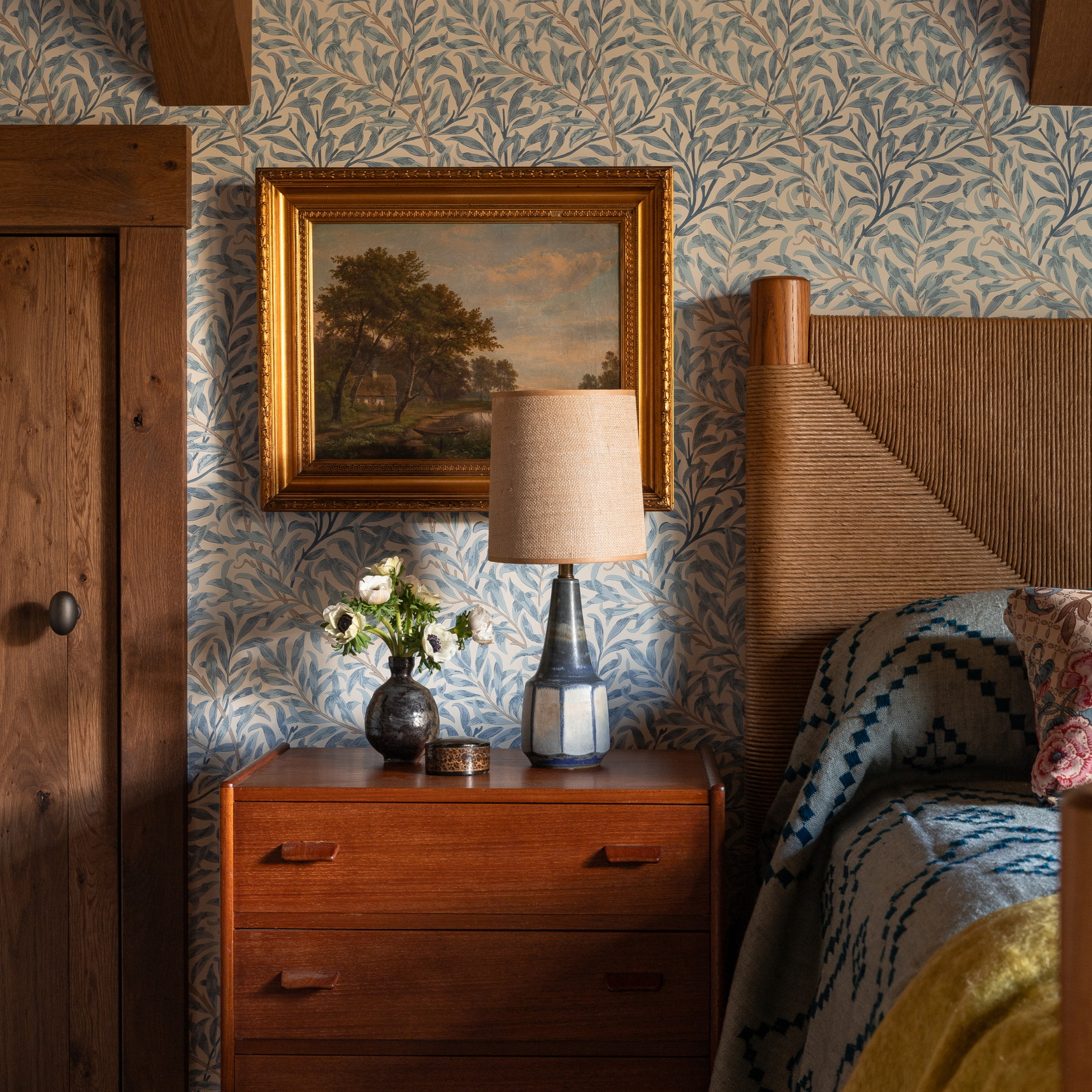 a bedroom with a painting on the wall