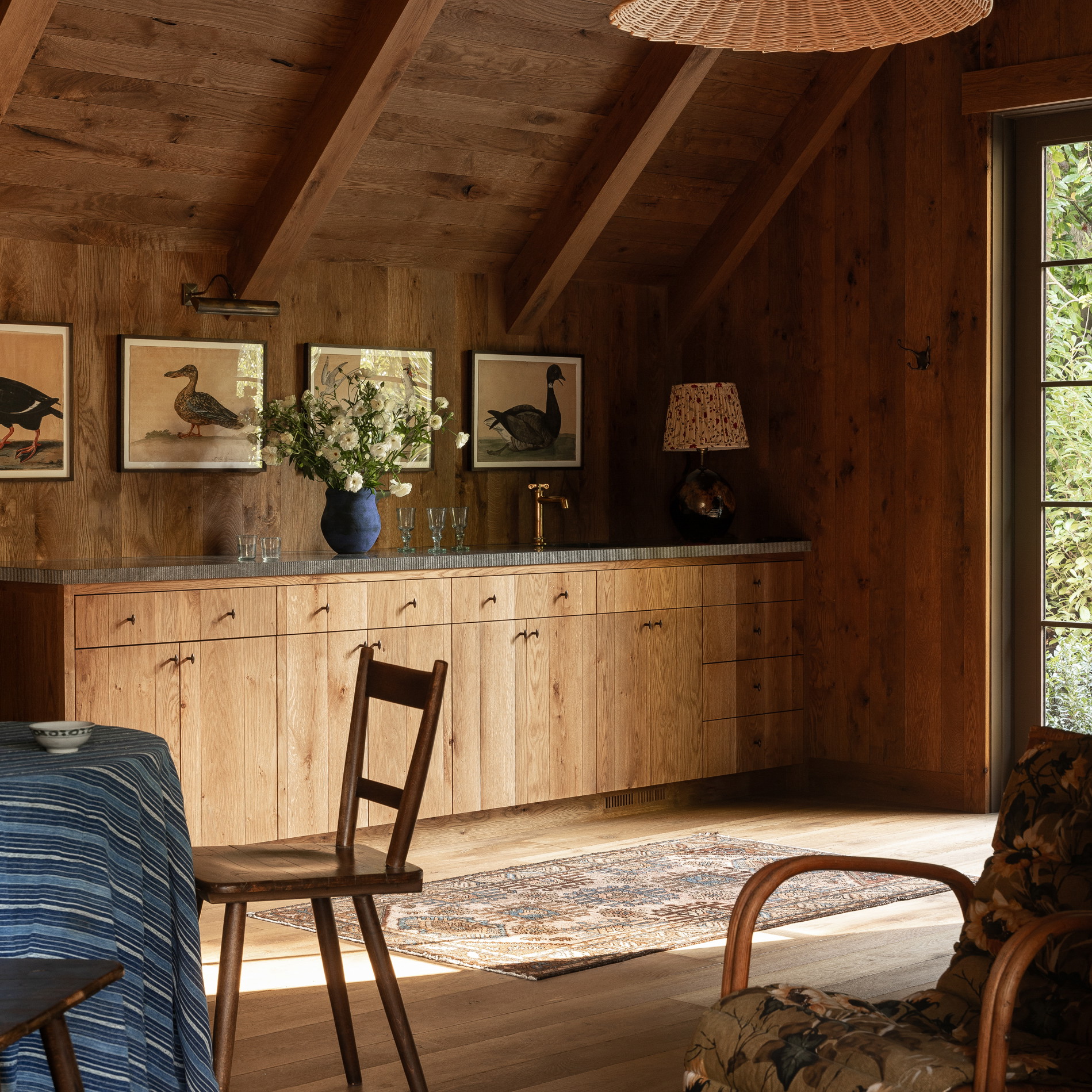 a room with a table, chairs, and pictures on the wall