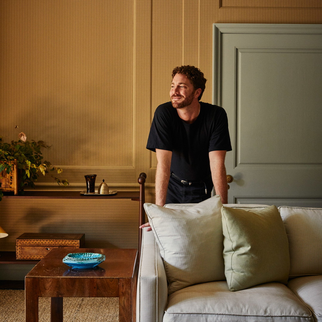 a man sitting on a couch in a living room