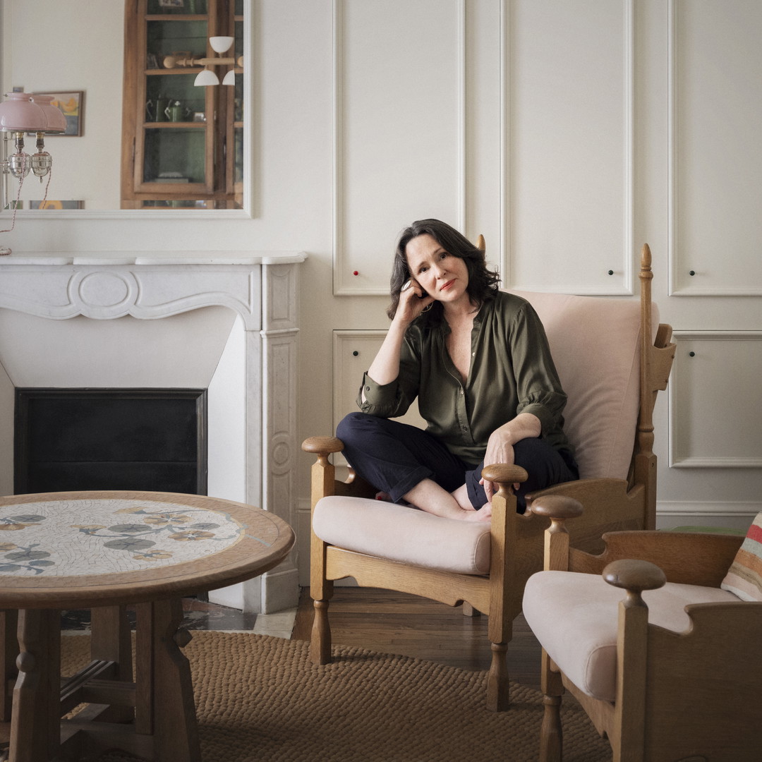 a woman sitting in a chair in a living room