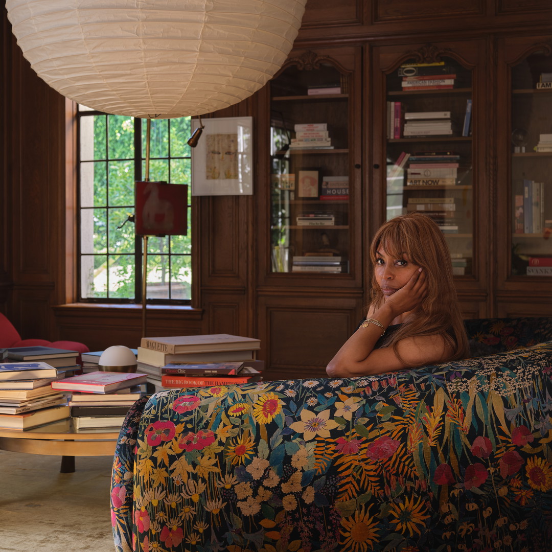 a woman sitting on a couch in a library