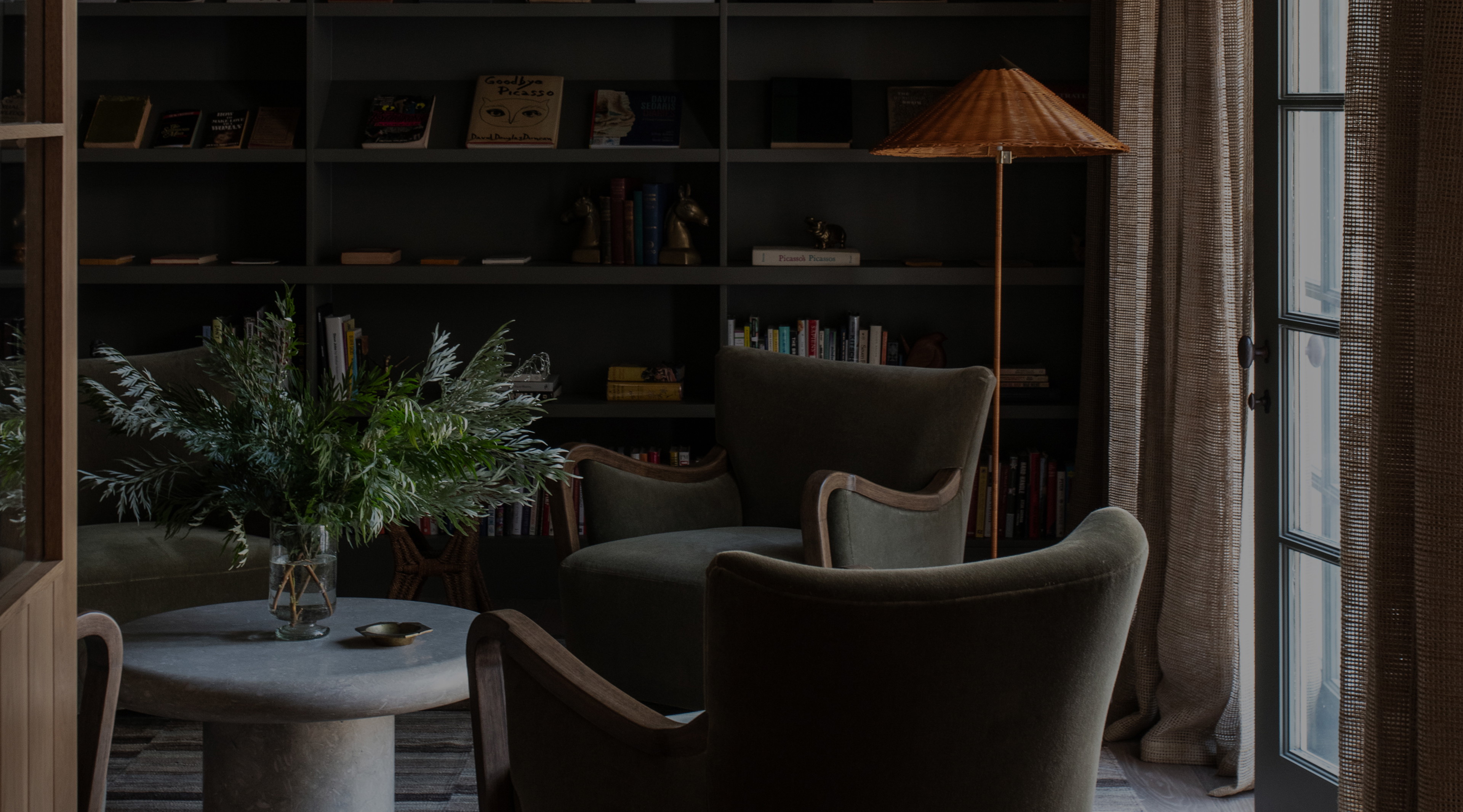 a living room filled with furniture and a book shelf