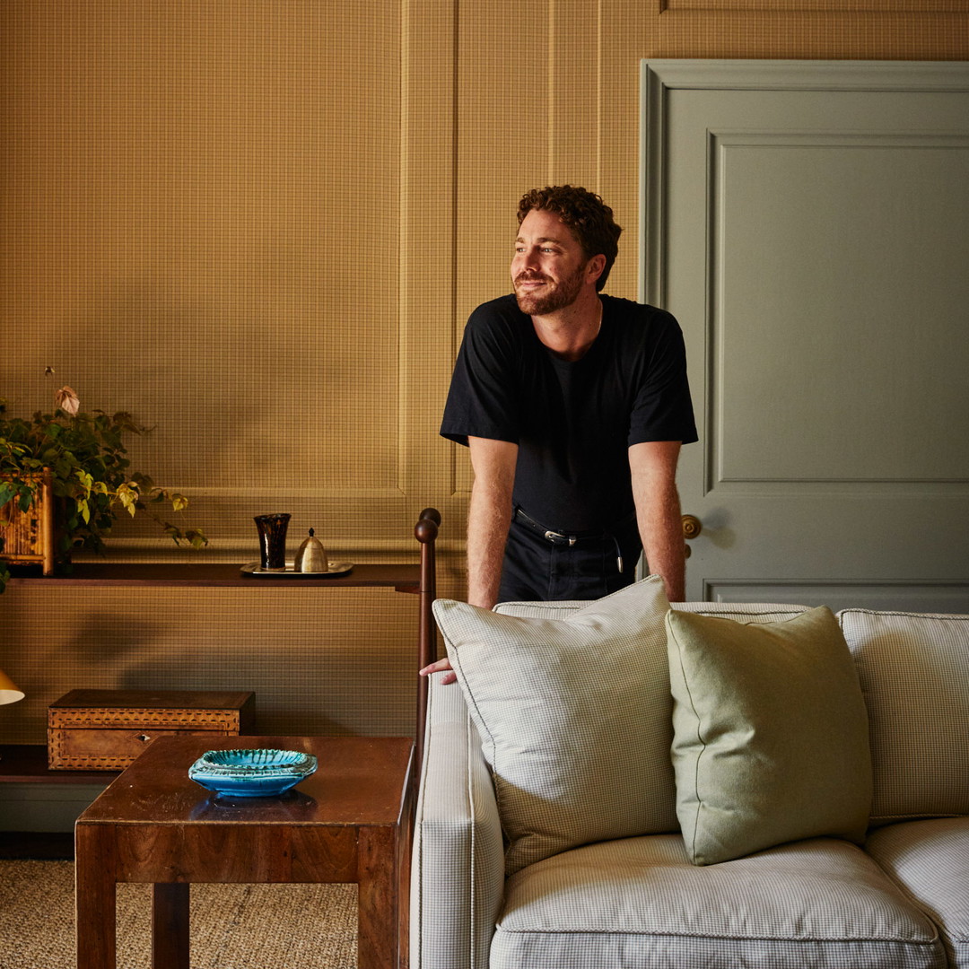 a man sitting on a couch in a living room