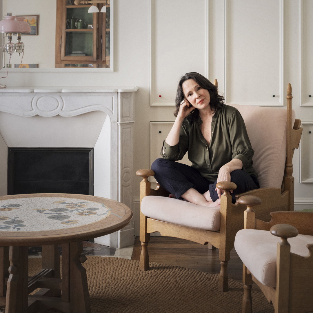 a woman sitting in a chair in a living room