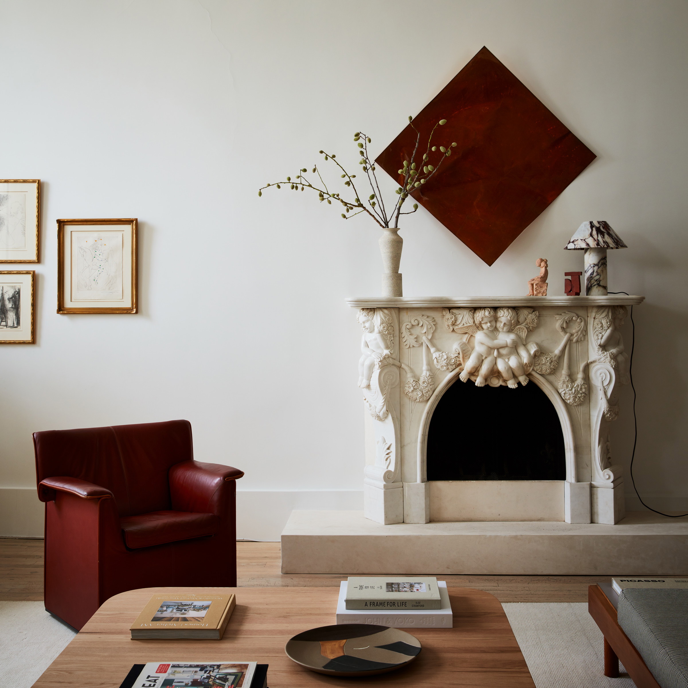 a living room with a fire place and a red chair