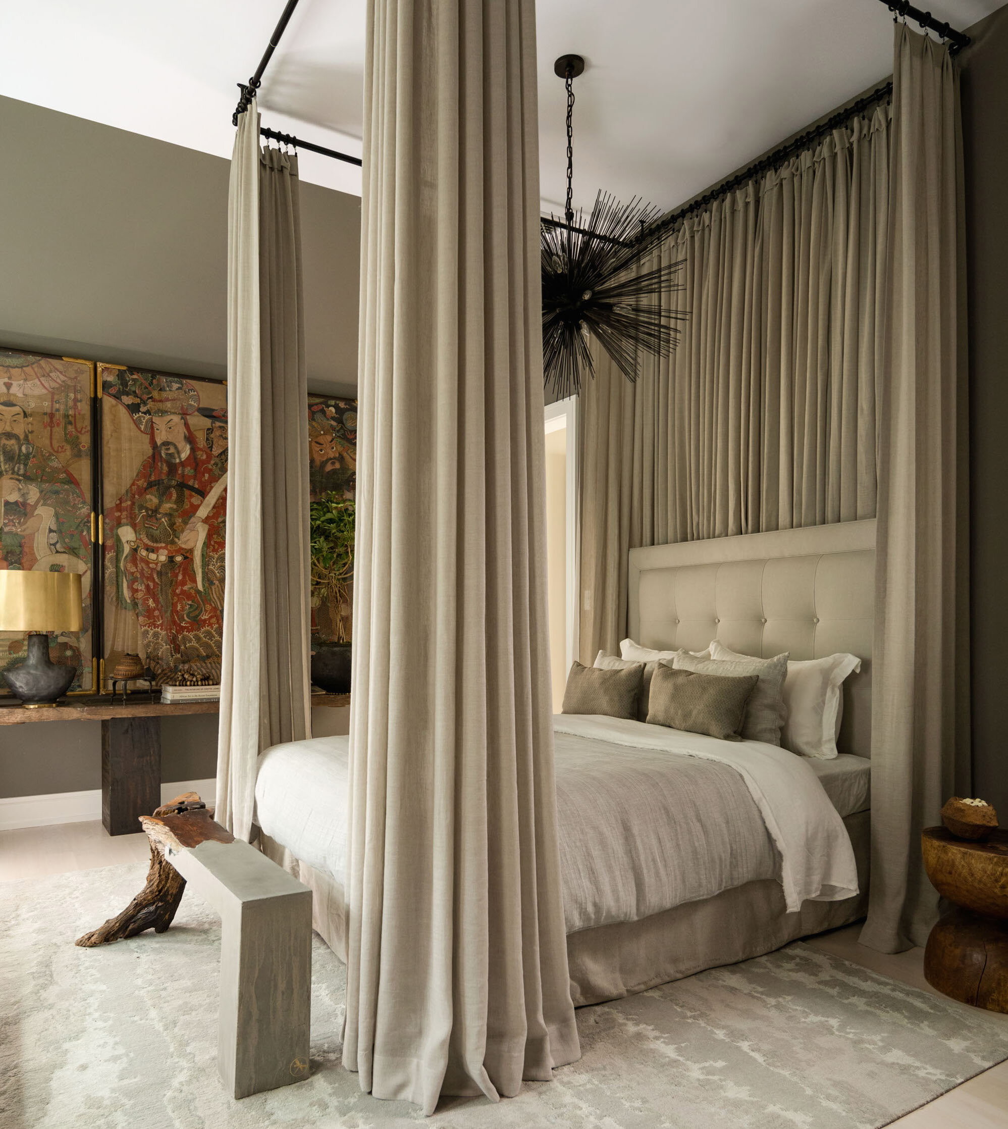 a bedroom with a canopy bed and curtains