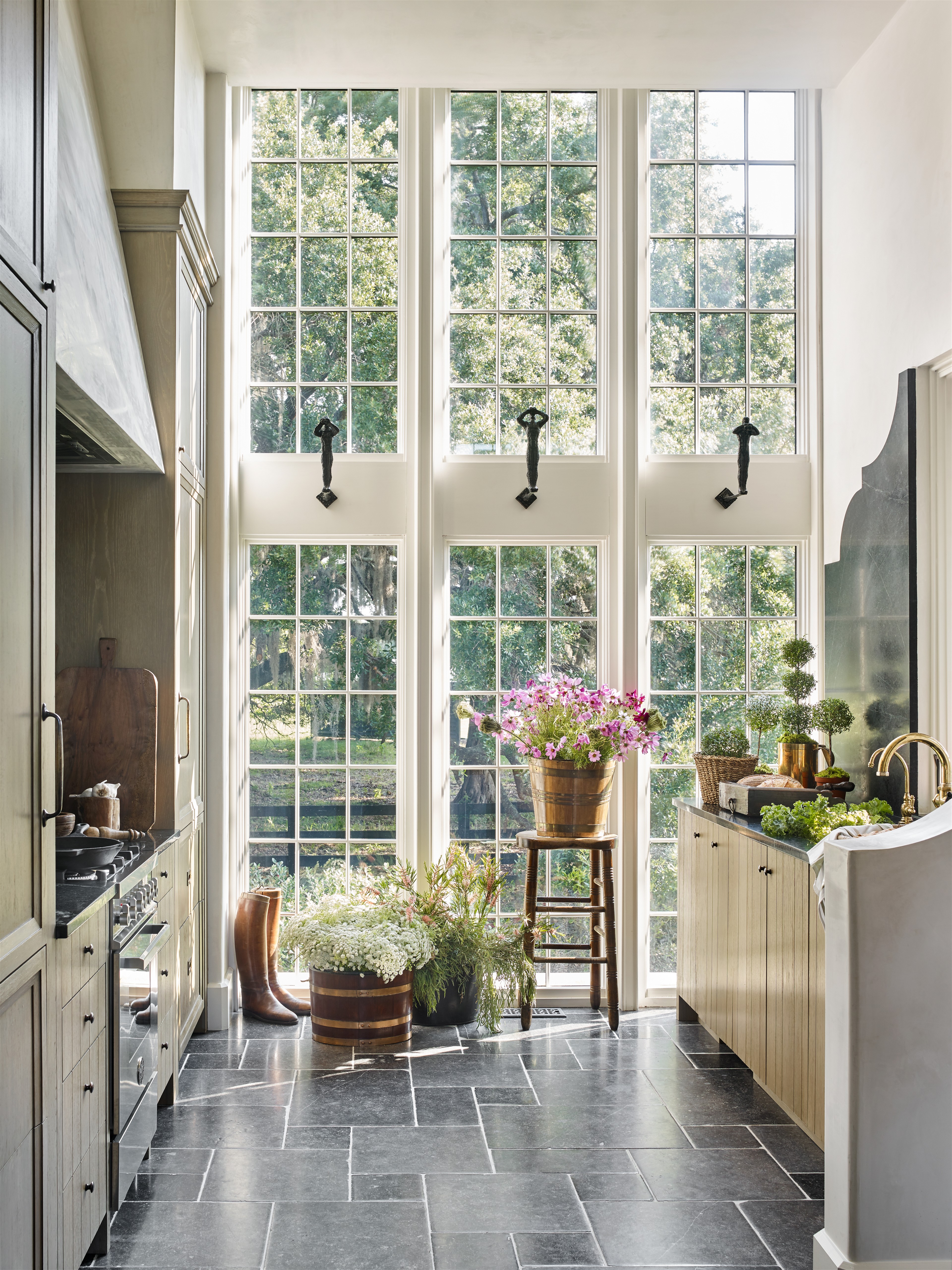 a kitchen filled with lots of windows next to a stove top oven