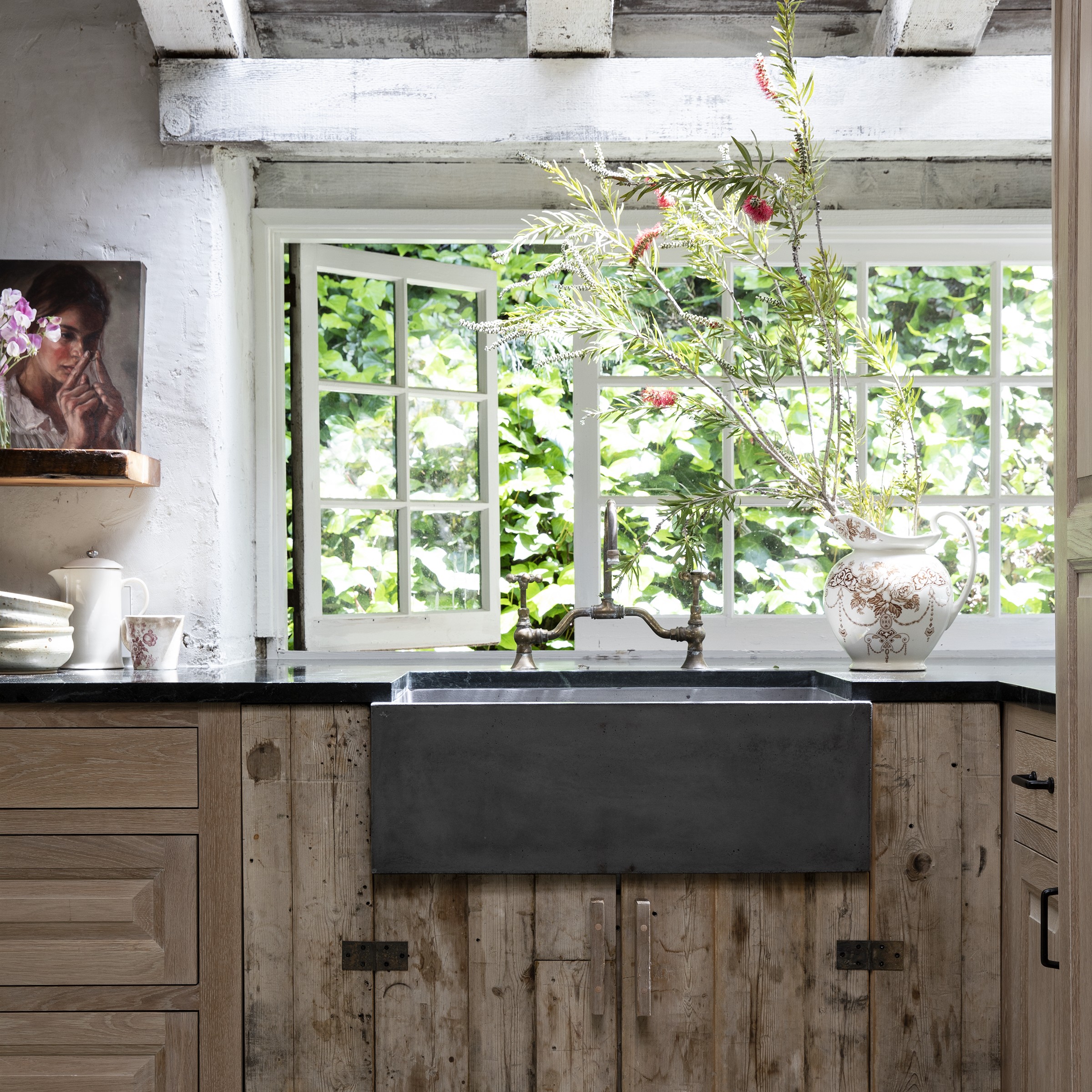 a kitchen with wooden cabinets and a black sink