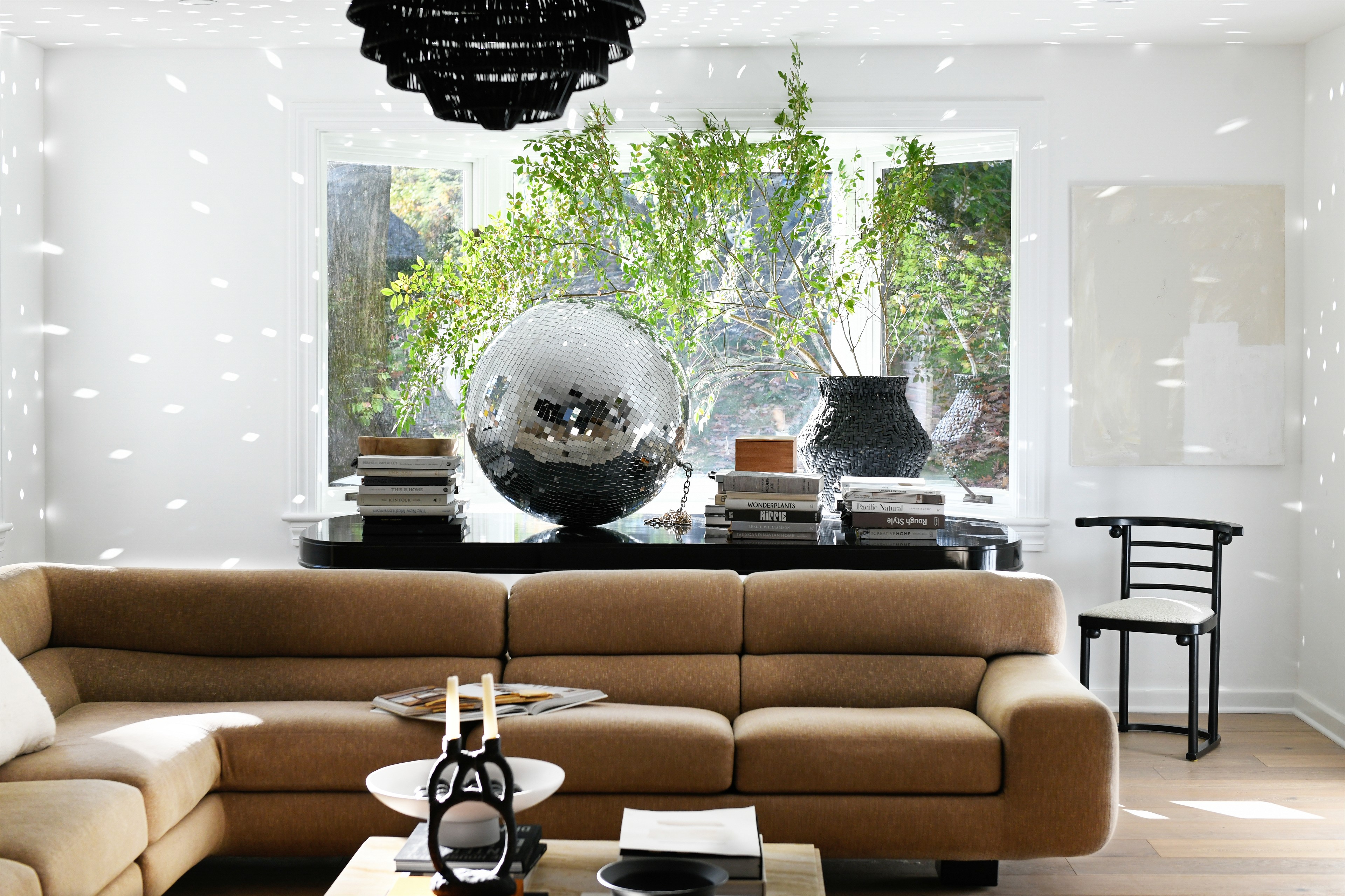 a living room filled with furniture and a large mirror ball