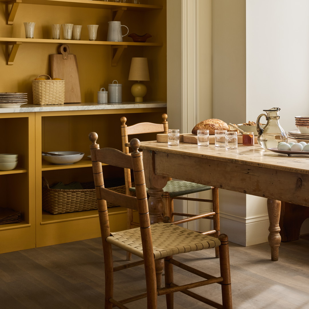 a dining room with a table and chairs