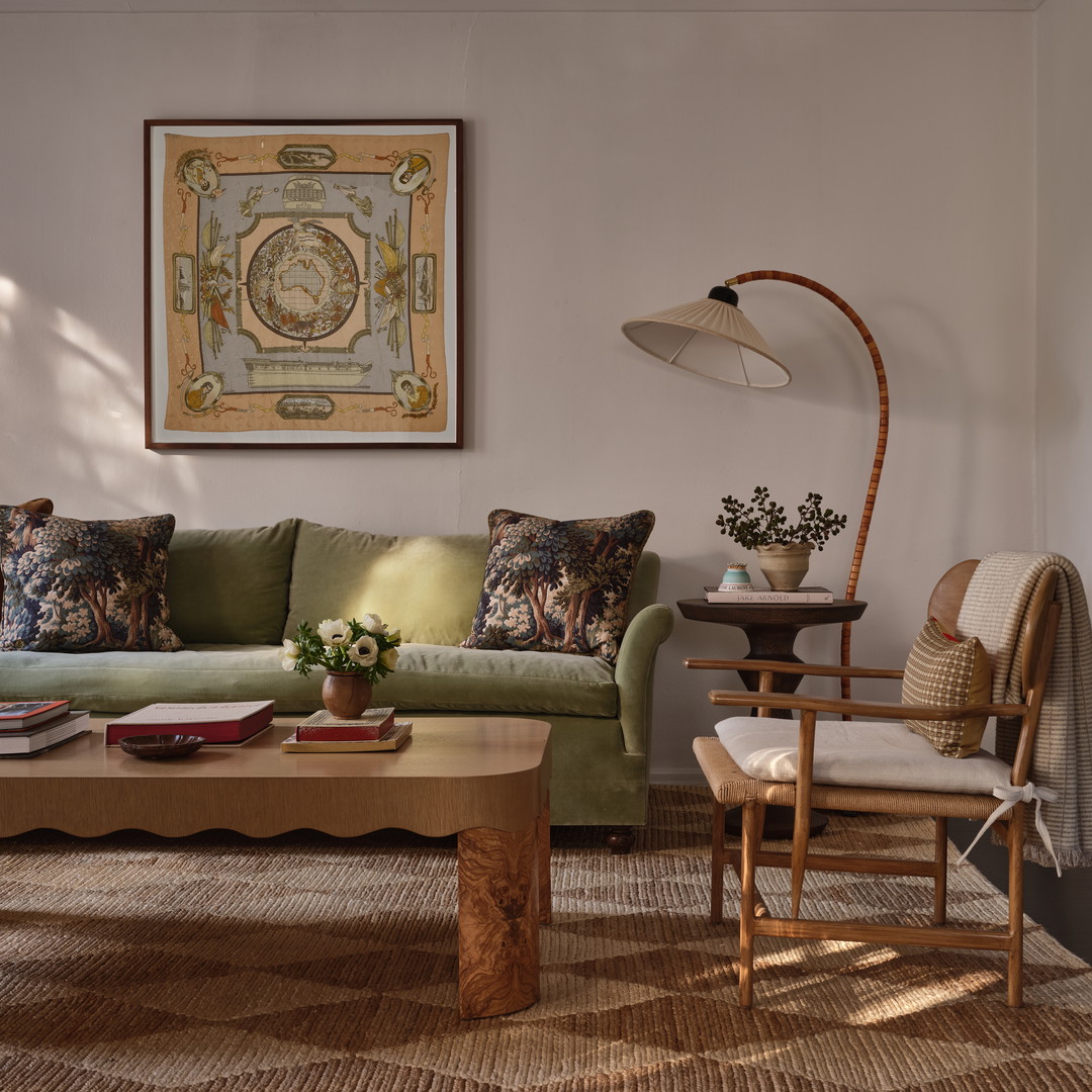 a living room filled with furniture and a painting on the wall