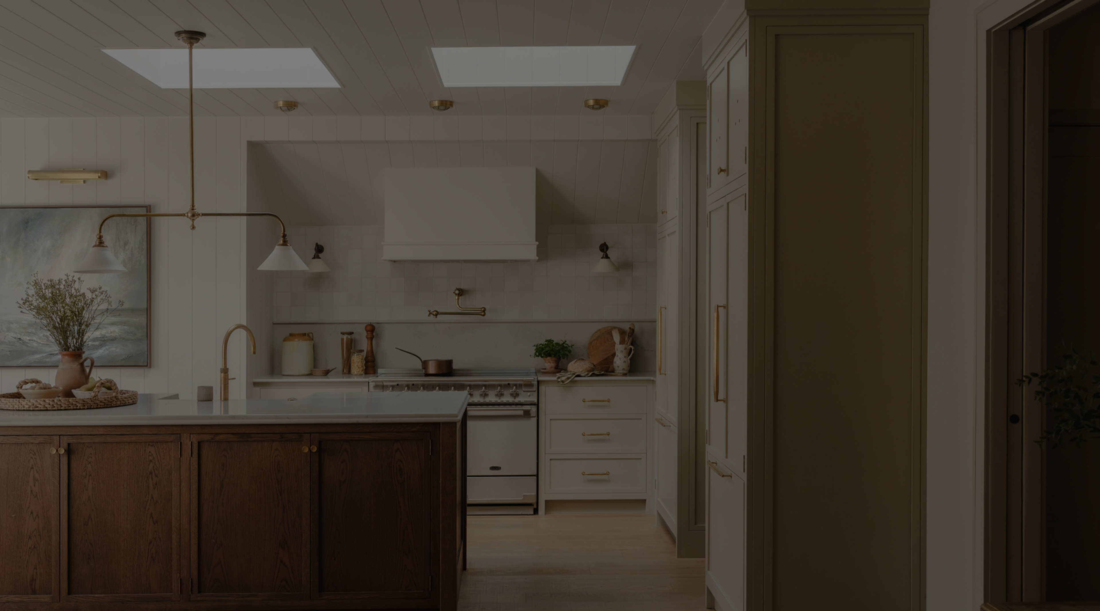 a kitchen with a center island and a painting on the wall