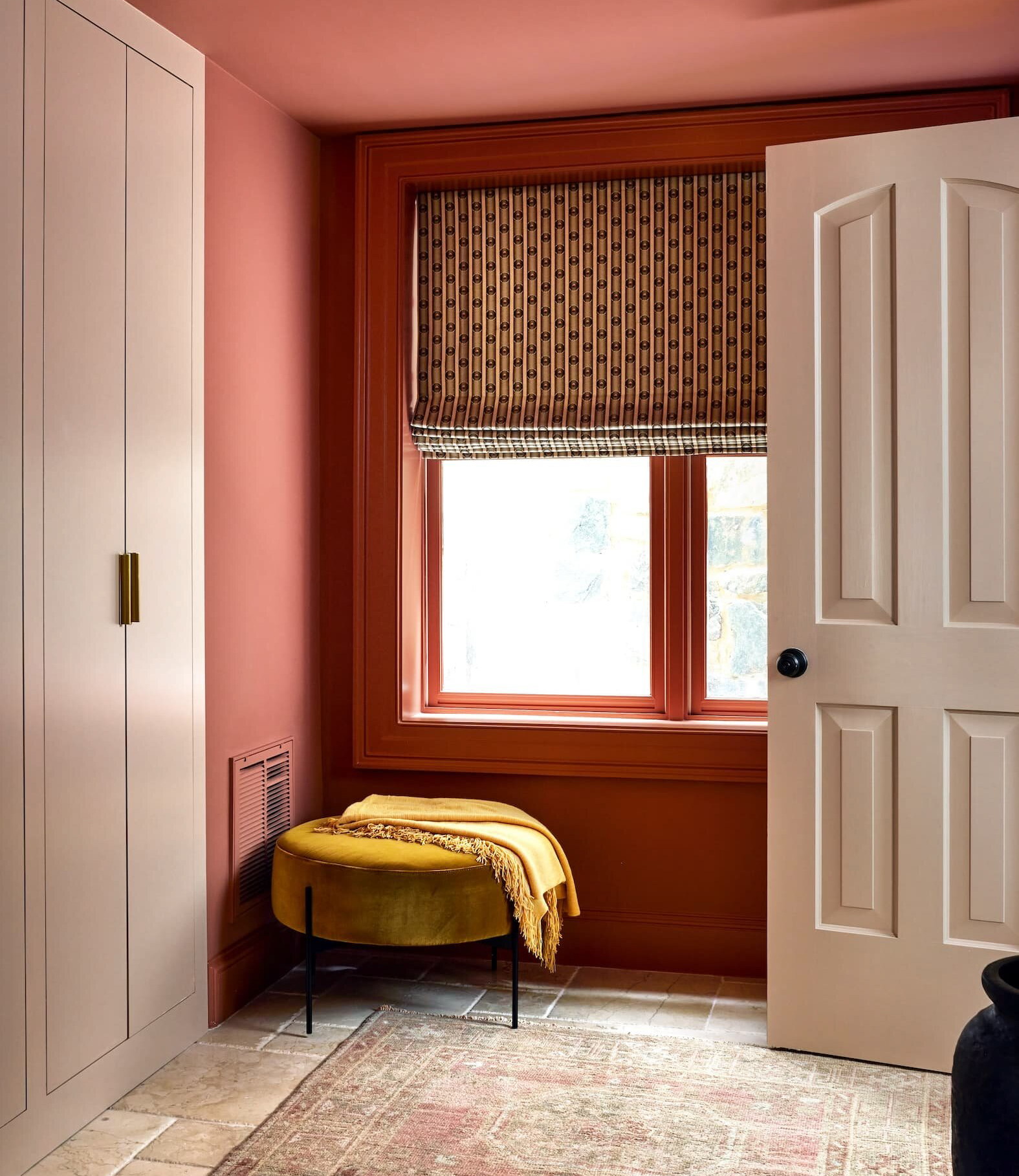 a bedroom with pink walls and a yellow bed