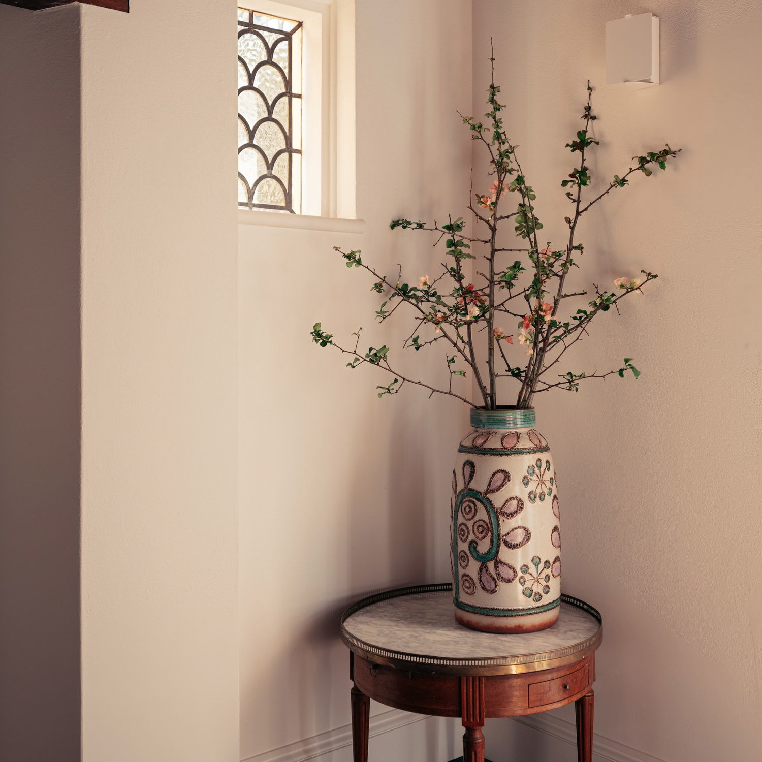 a vase with flowers on a table in a room