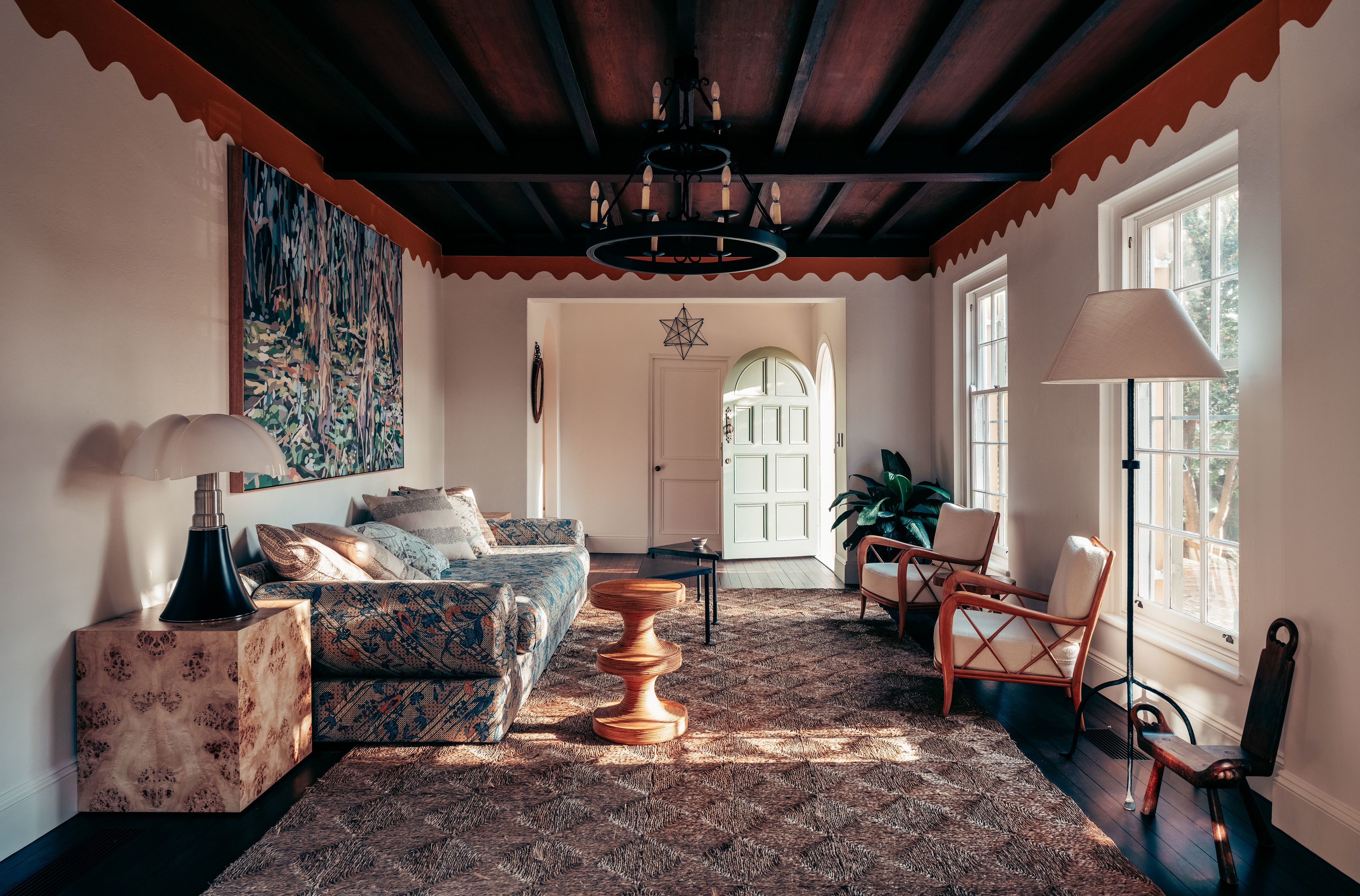 a living room filled with furniture and a lamp