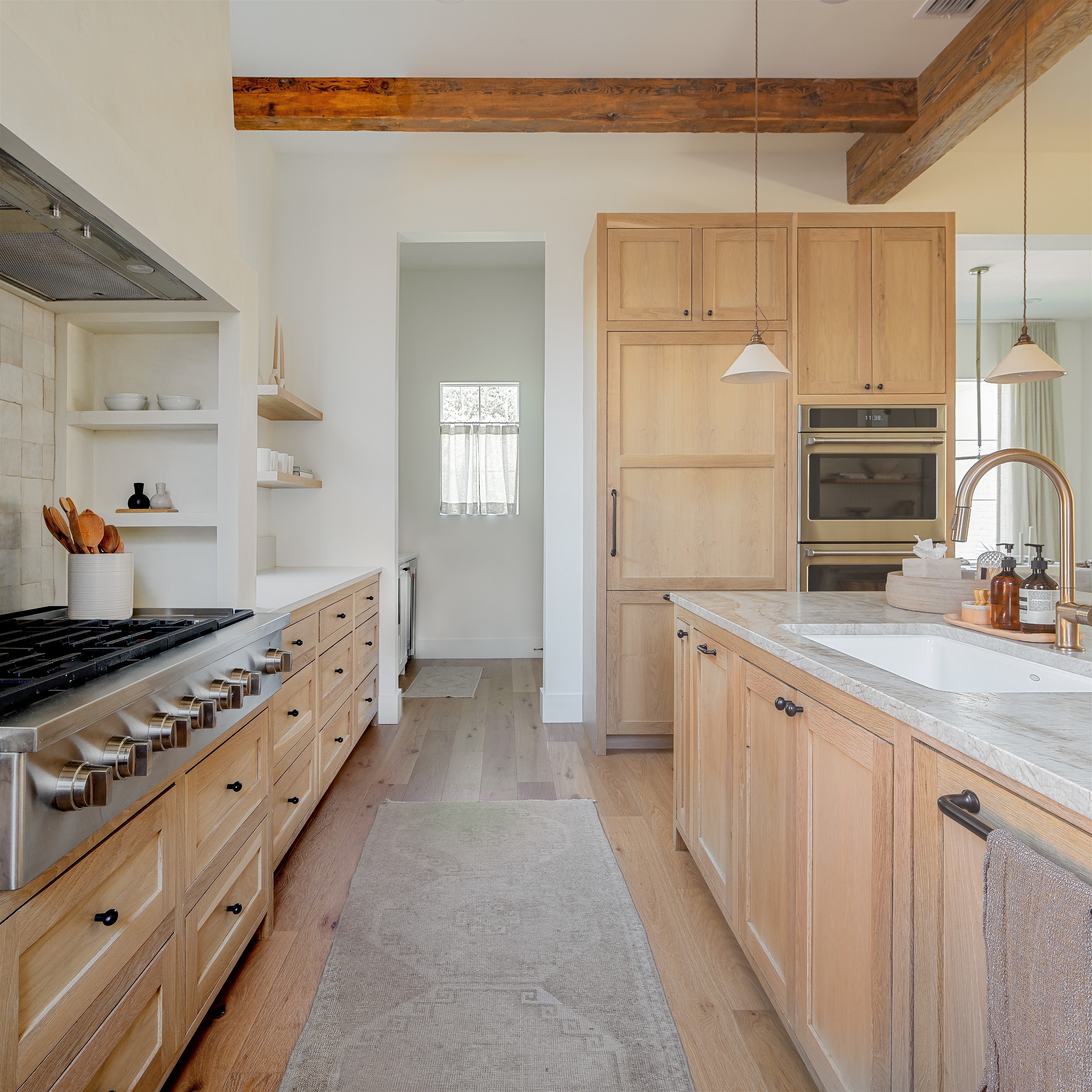 a kitchen with a stove top oven and wooden cabinets