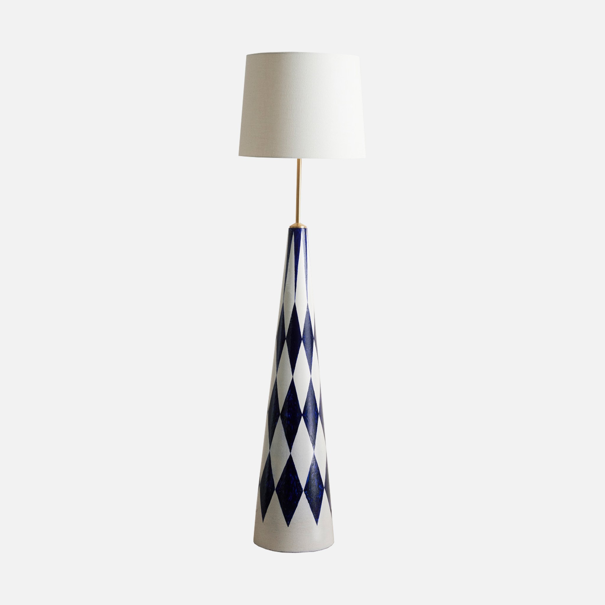 a blue and white table lamp with a white shade
