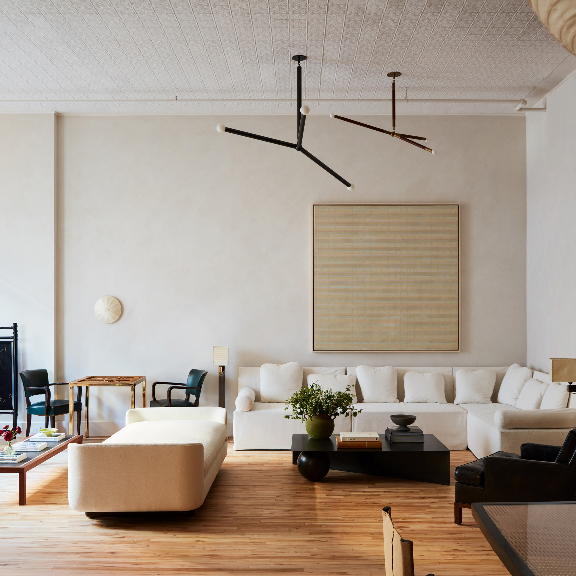 a living room filled with furniture and a tree