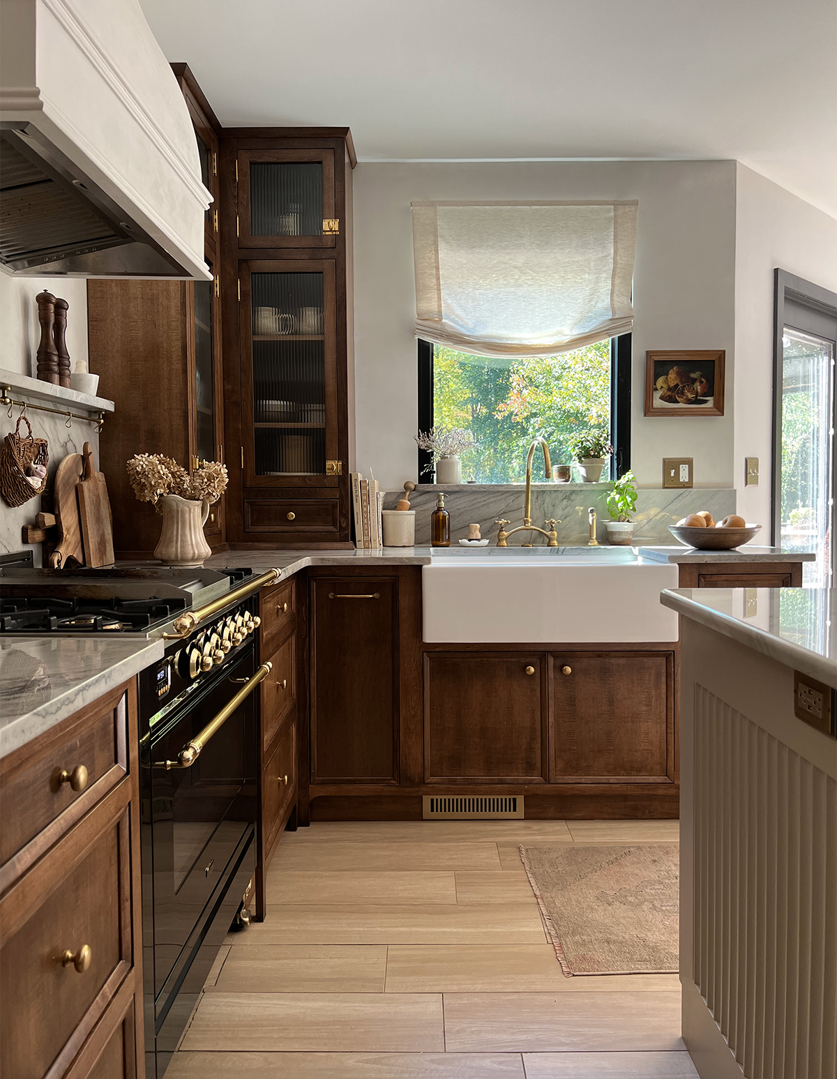 a kitchen with a stove, sink, and cabinets