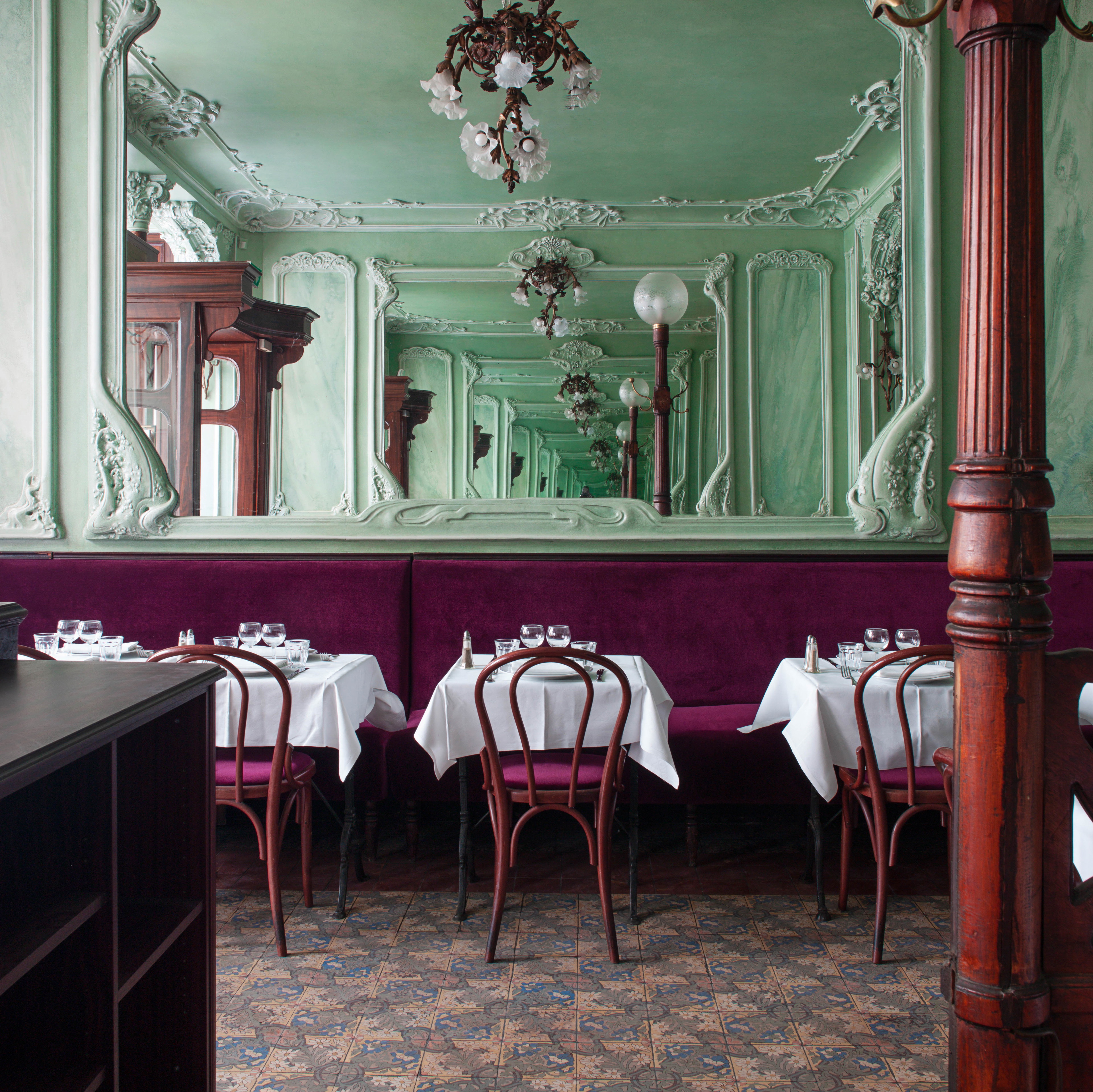 a dining room with tables and chairs and a chandelier