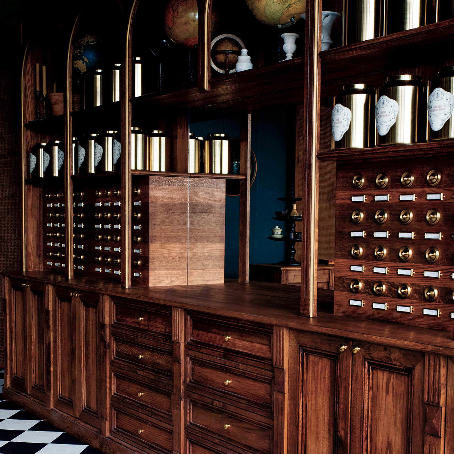 a room with a checkered floor and wooden cabinets