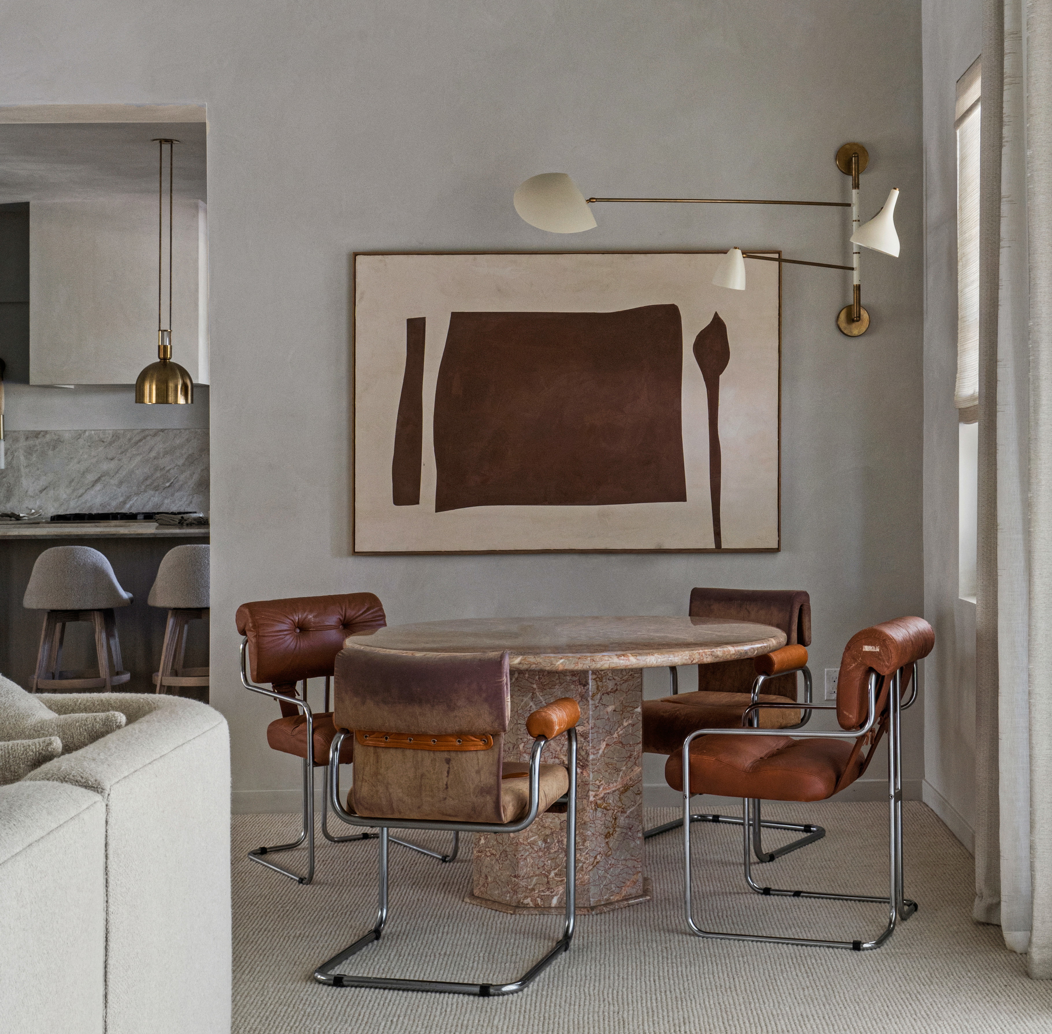 a living room with a couch a table and chairs