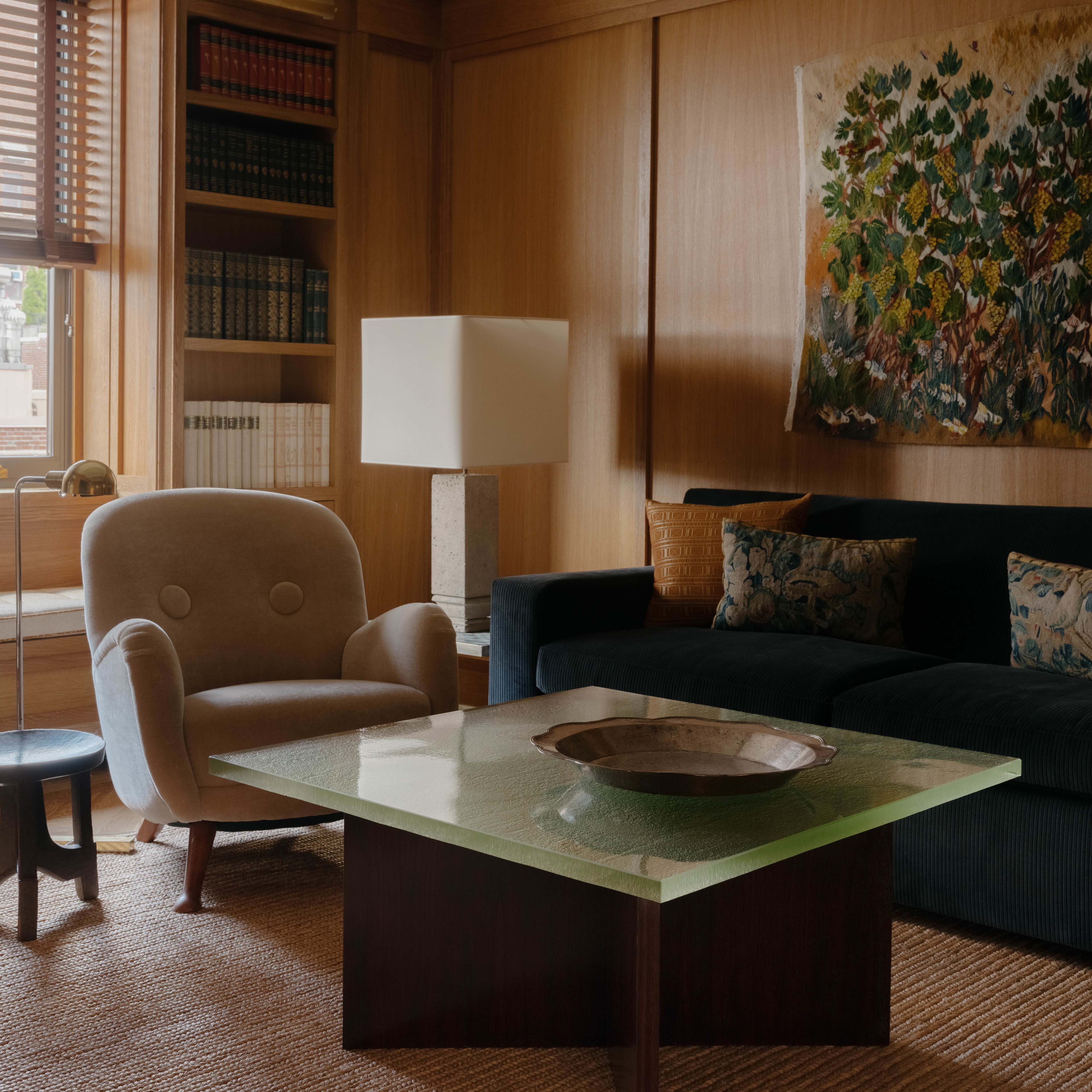 a living room filled with furniture and a painting on the wall