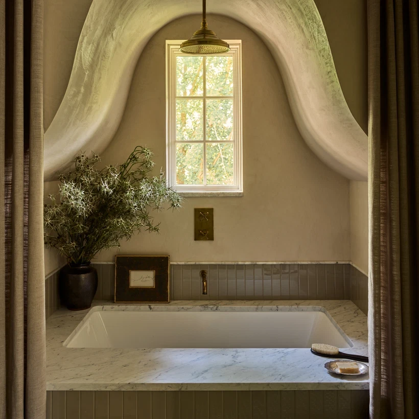 a bathroom with a tub and a window