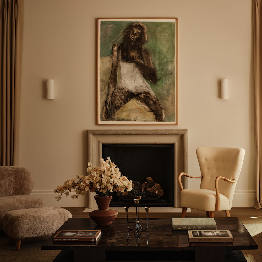 a living room filled with furniture and a painting on the wall