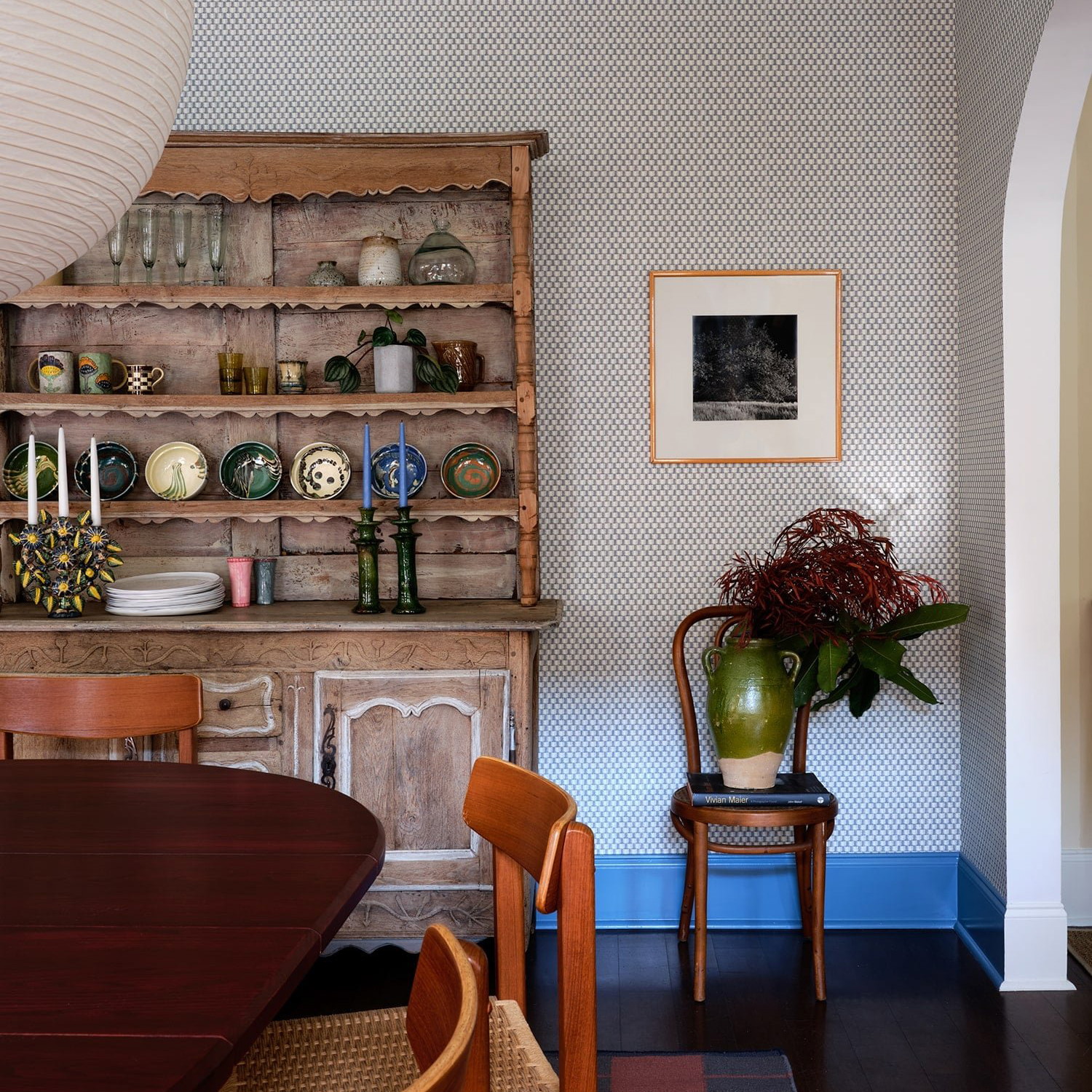 a dining room with a wooden table and chairs