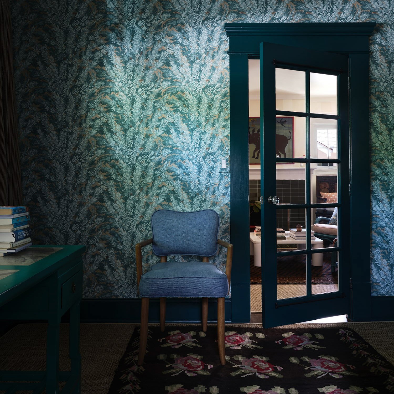 a blue chair sitting in a room next to a doorway