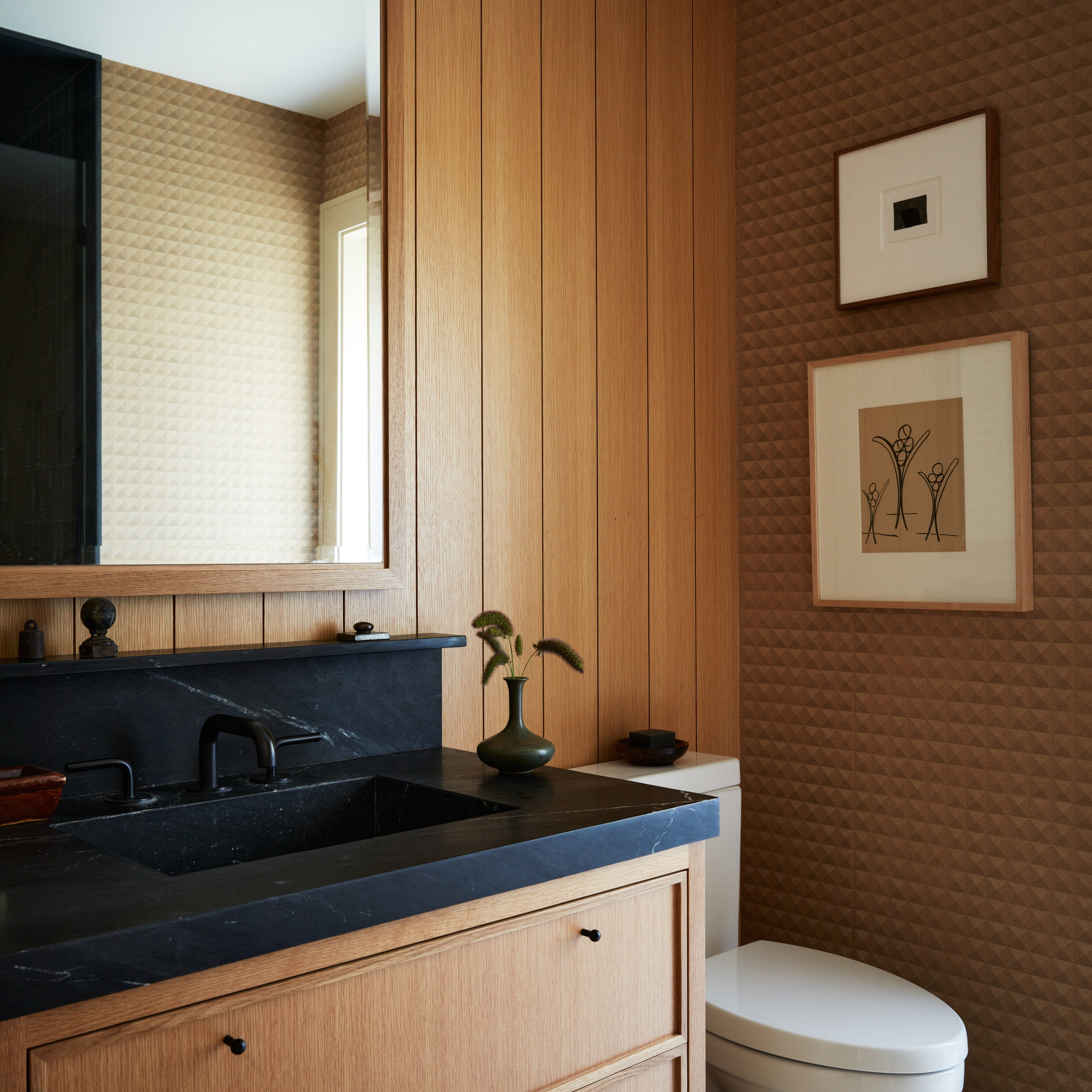 a bathroom with wood paneling and a white toilet