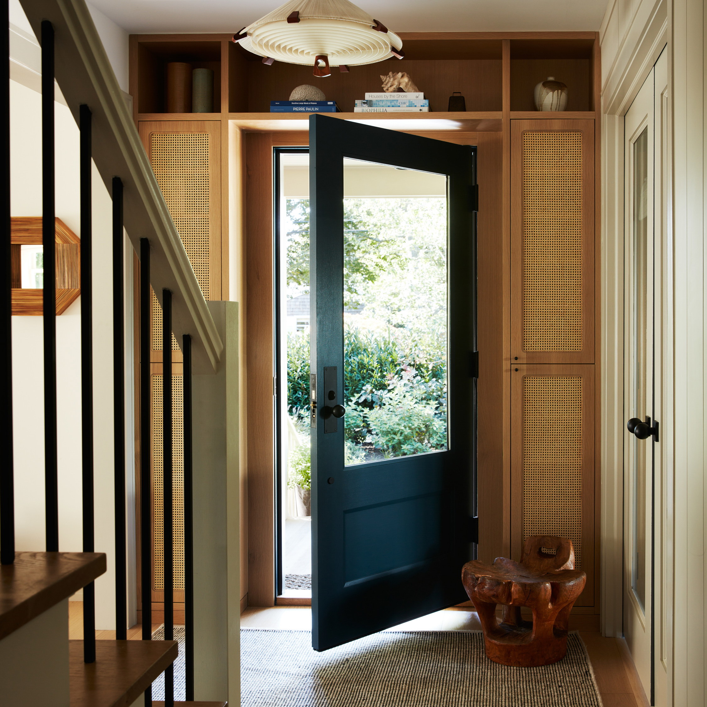 a black door is open on a wooden floor