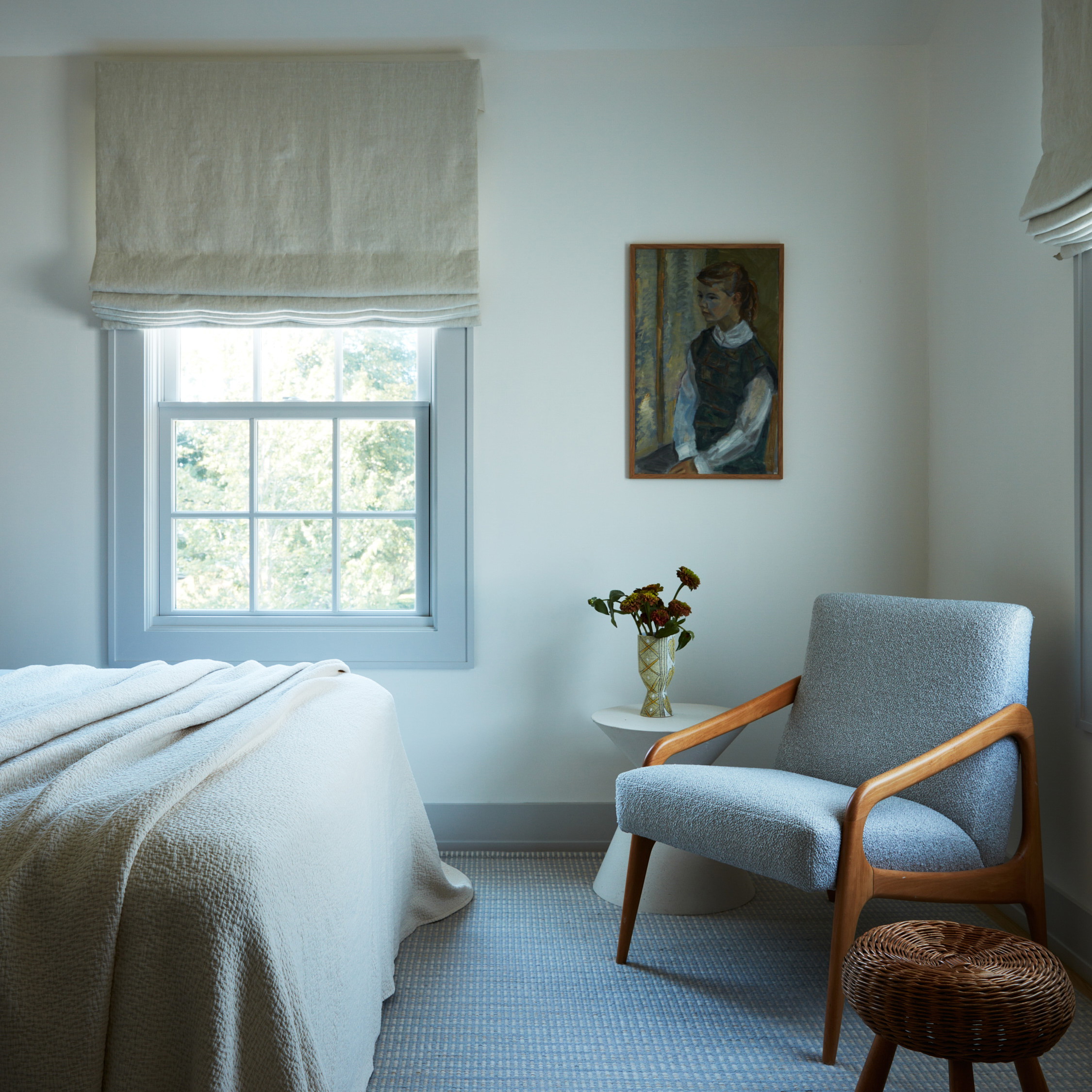 a bedroom with a chair and a bed